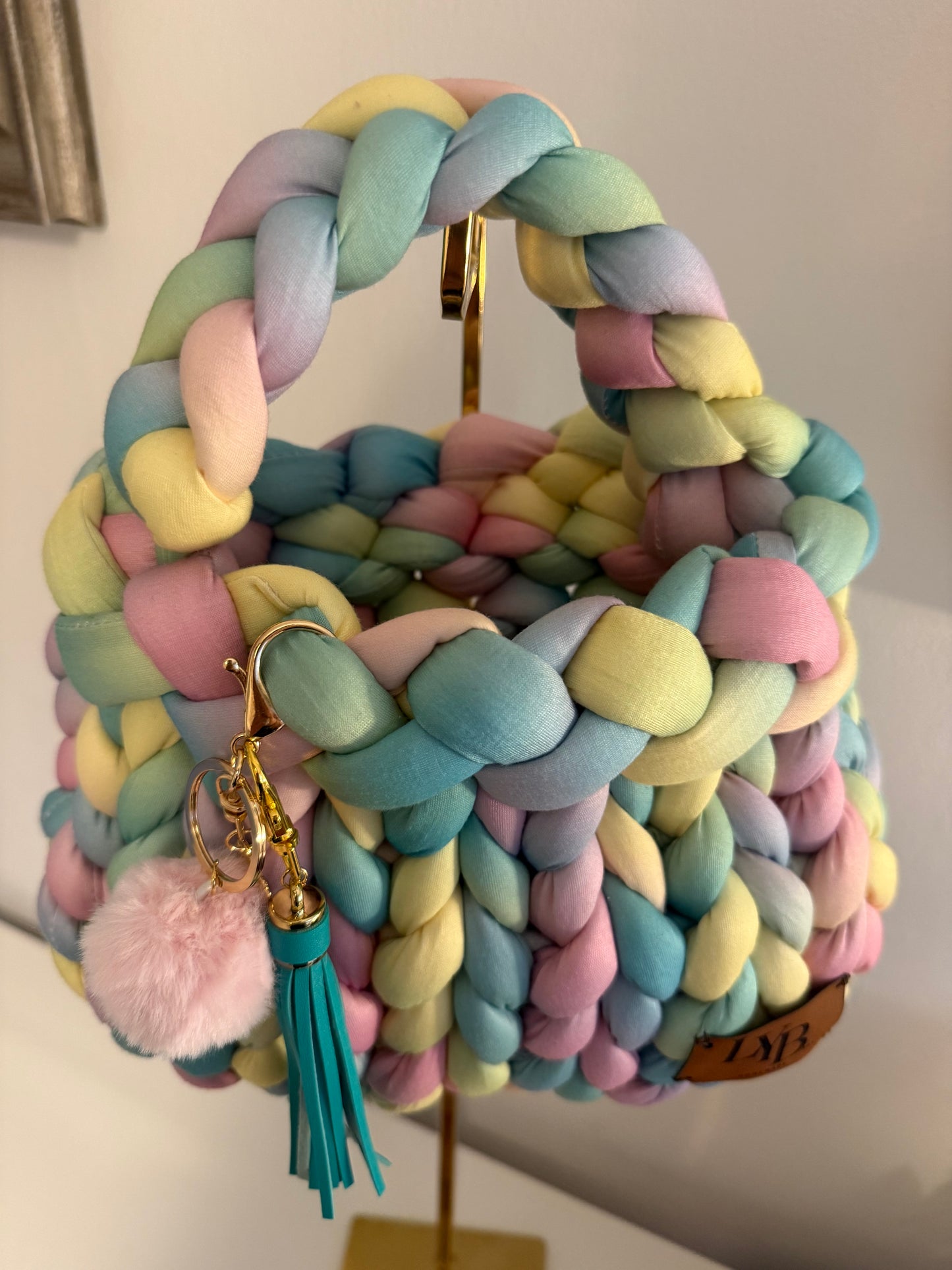 Candy pastel chunky braided bag showing braided top handle and open interior - side view