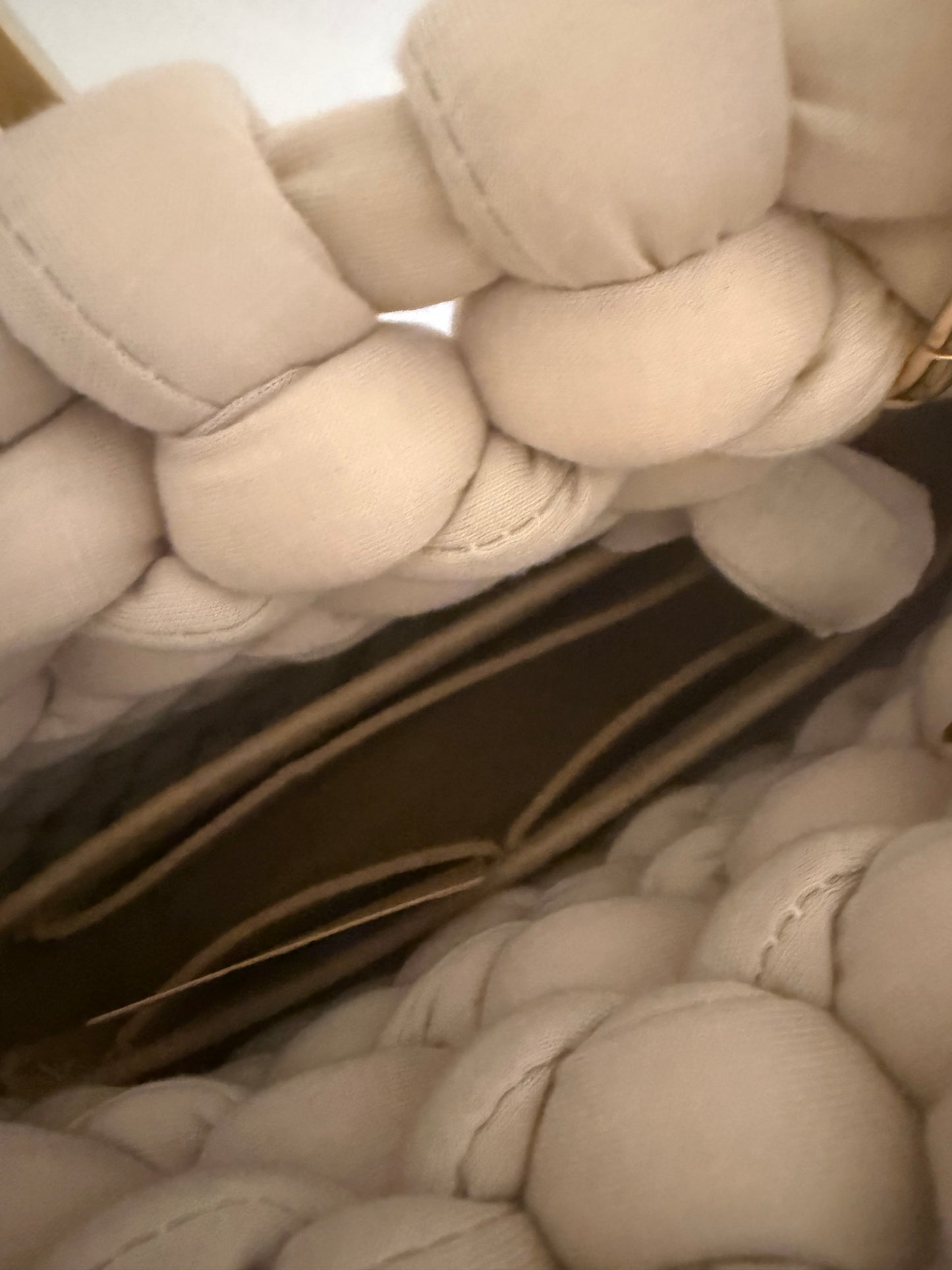 Interior view of Pippa chunky braid bag showing rich dark inner liner and structured base