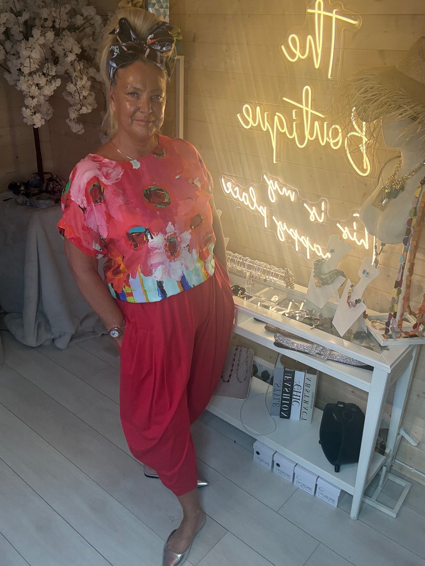 Model posing in Valencia Red Abstract Floral Top with red harem trousers showing complete tonal co-ord outfit