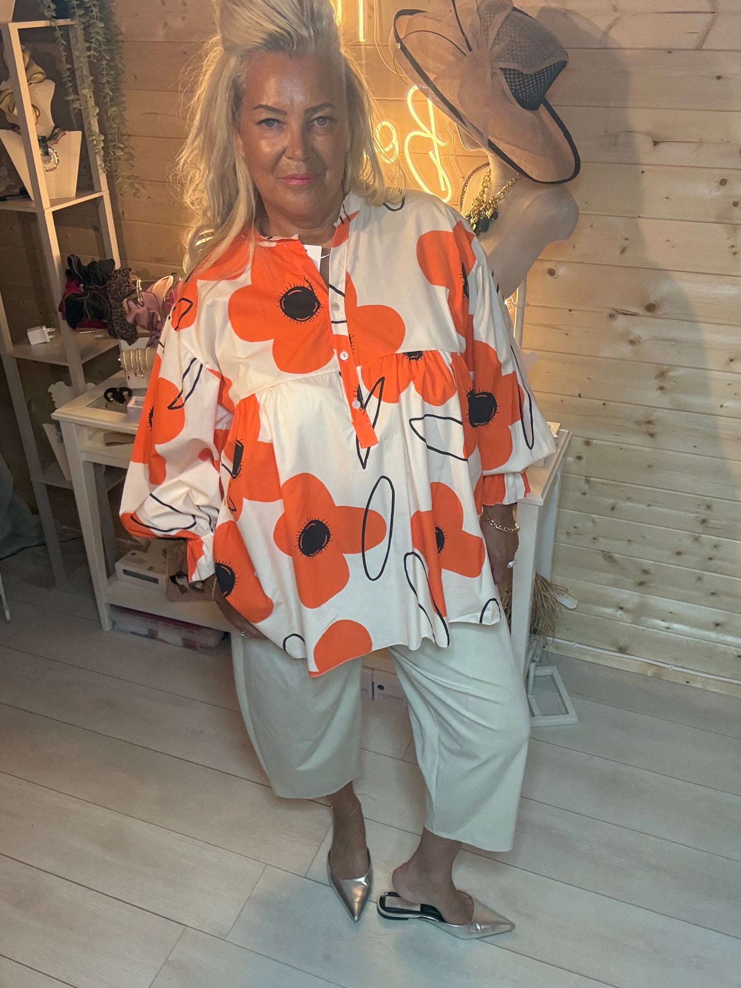 Orange and white floral button blouse – full length boutique shot showing oversized fit and gathered waist detail