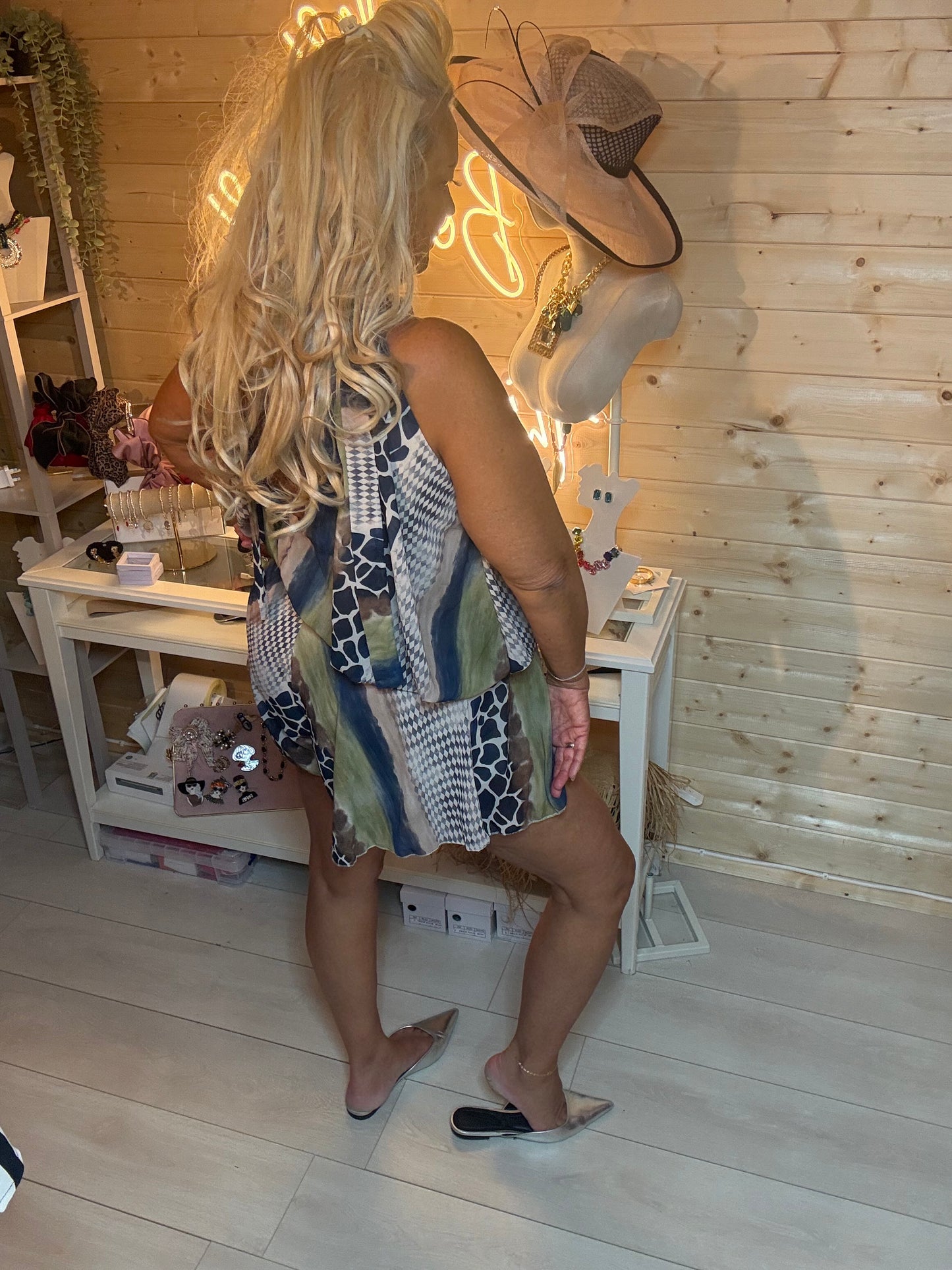 Mixed animal print playsuit – side back view showing full silhouette, peplum layer and shorts length with silver mules