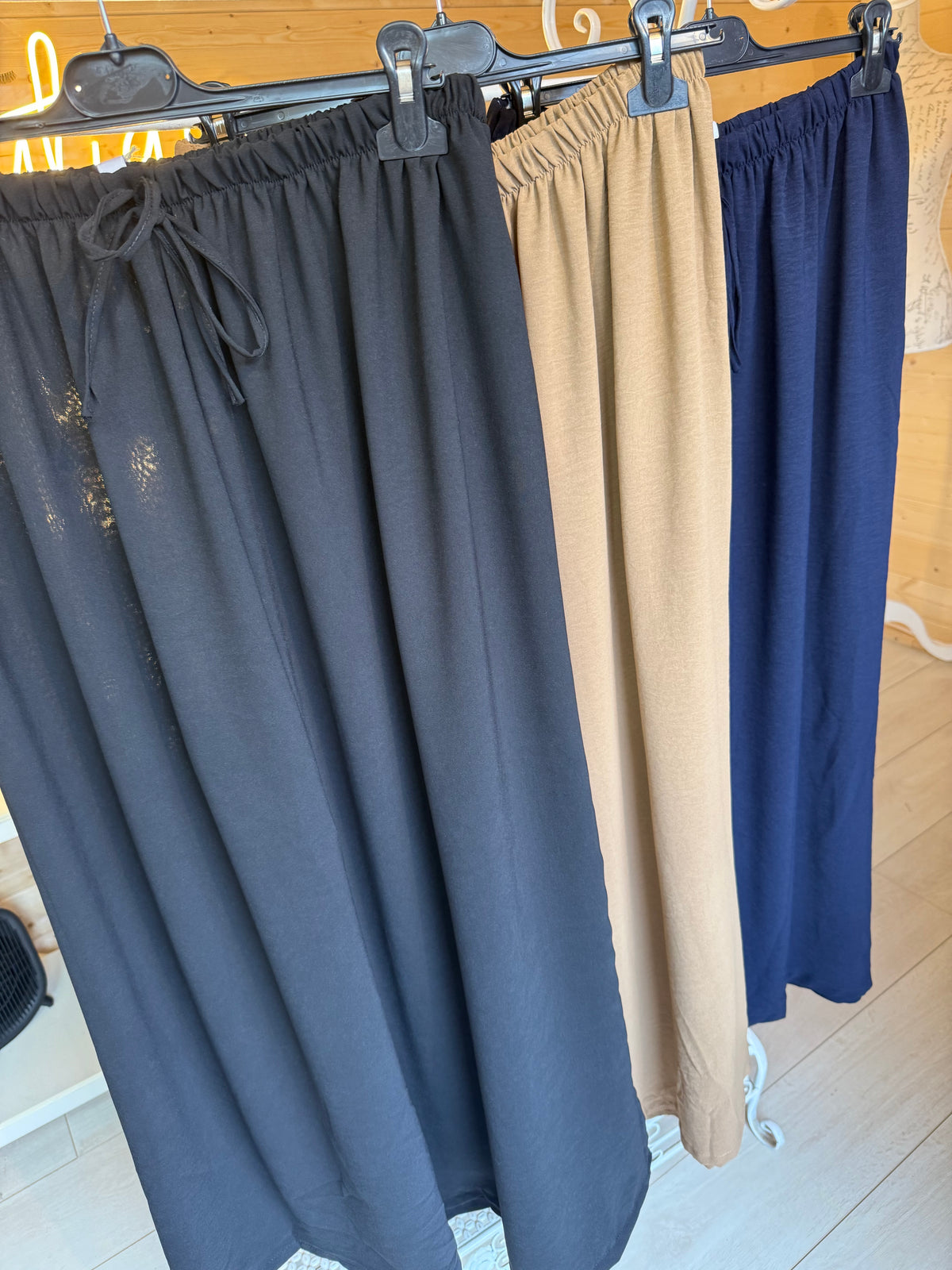Noli elasticated waist wide-leg trousers in Black, Camel and Navy displayed together