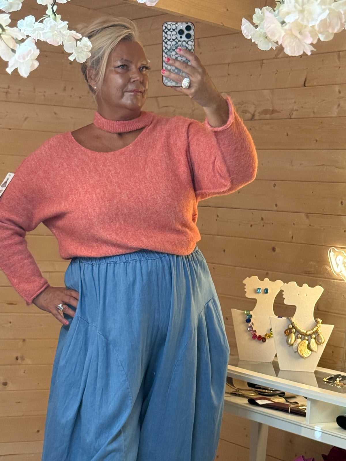 Close view of salmon pink Mira ladies knitted jumper showing choker neckline and soft texture