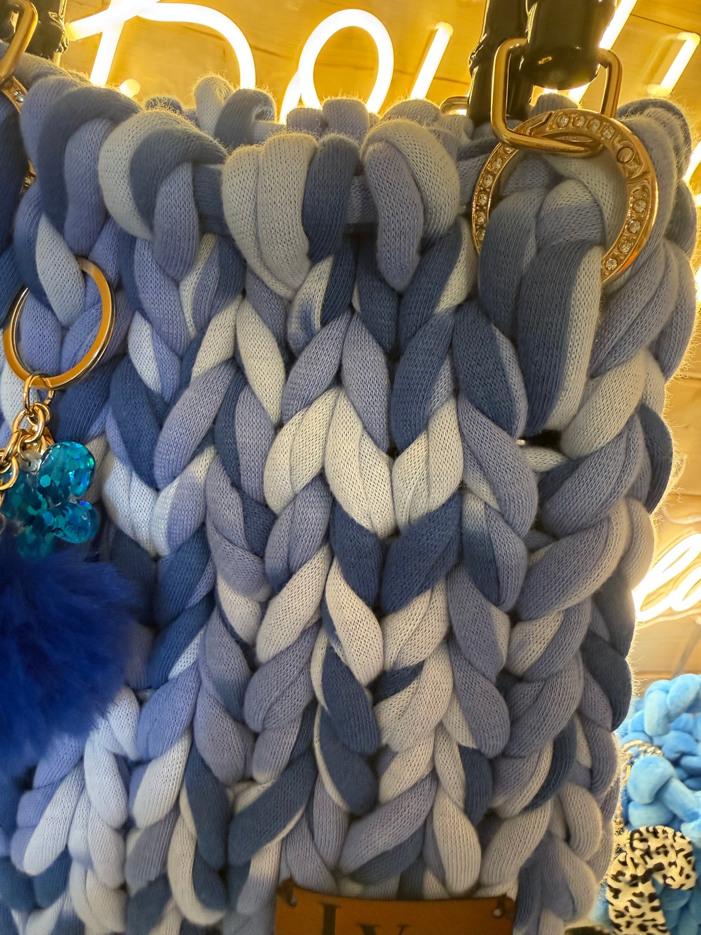 Azure ombré chunky knit tote bag detachable navy pom pom and teal crystal charm keyring close up
