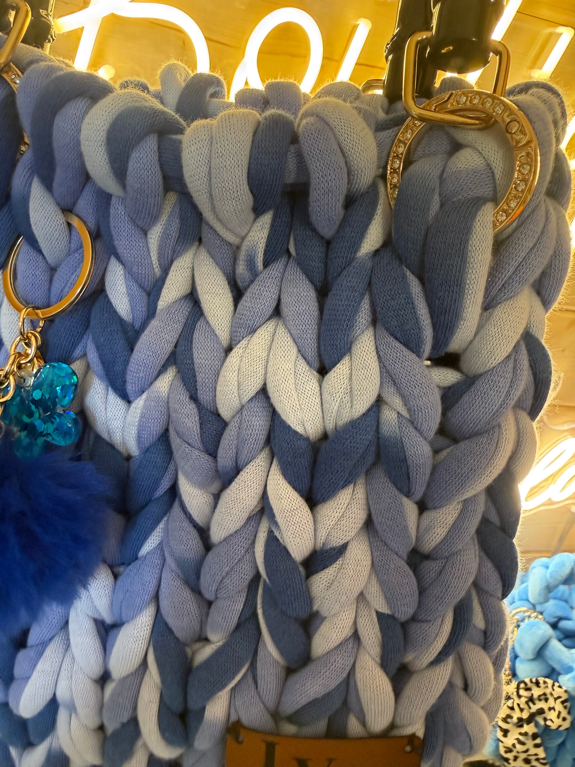 Azure ombré chunky knit tote bag detachable navy pom pom and teal crystal charm keyring close up