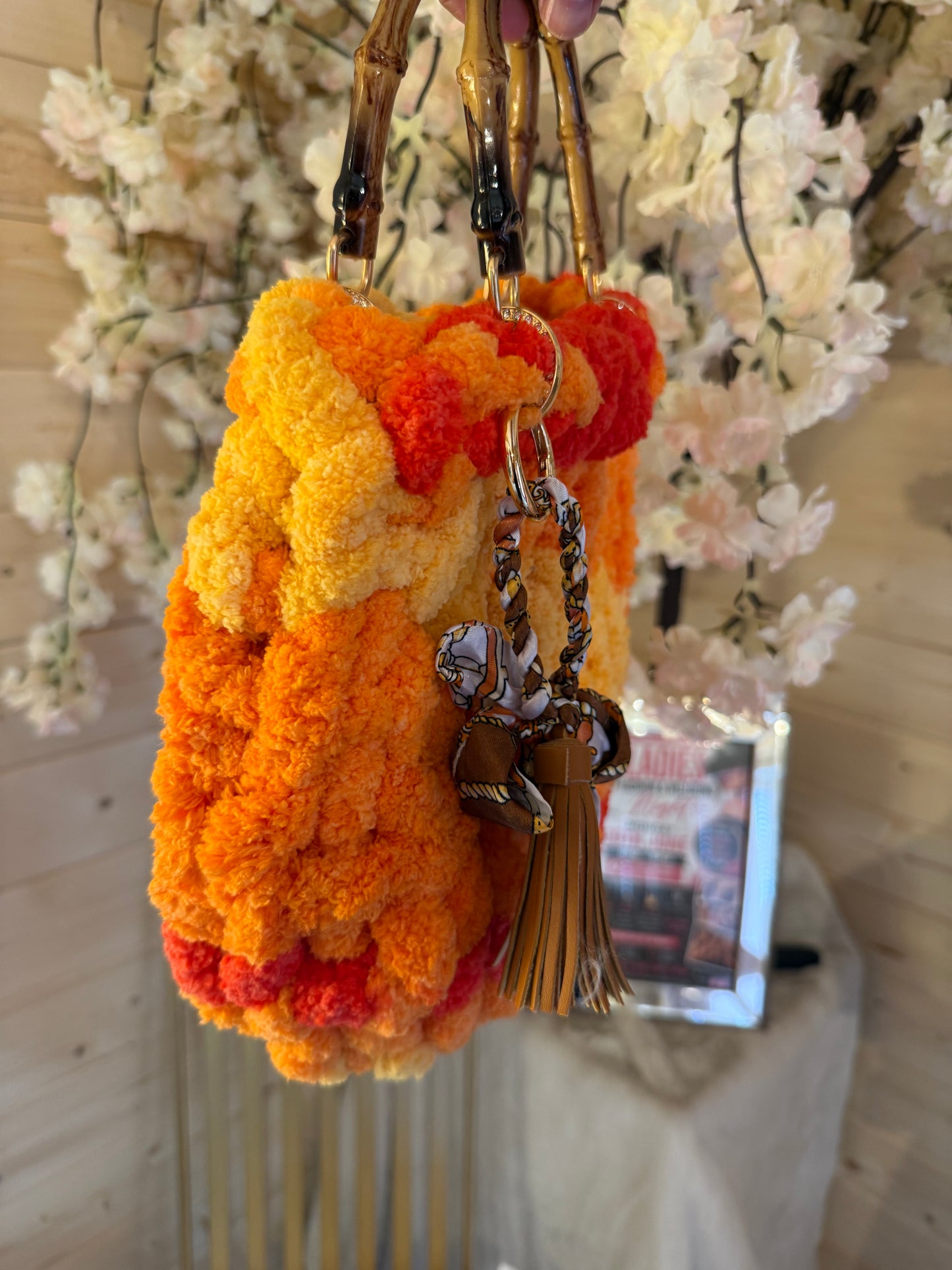 Sunset blaze chunky velvet knit bamboo bag side view with silk scarf and leather tassel charm