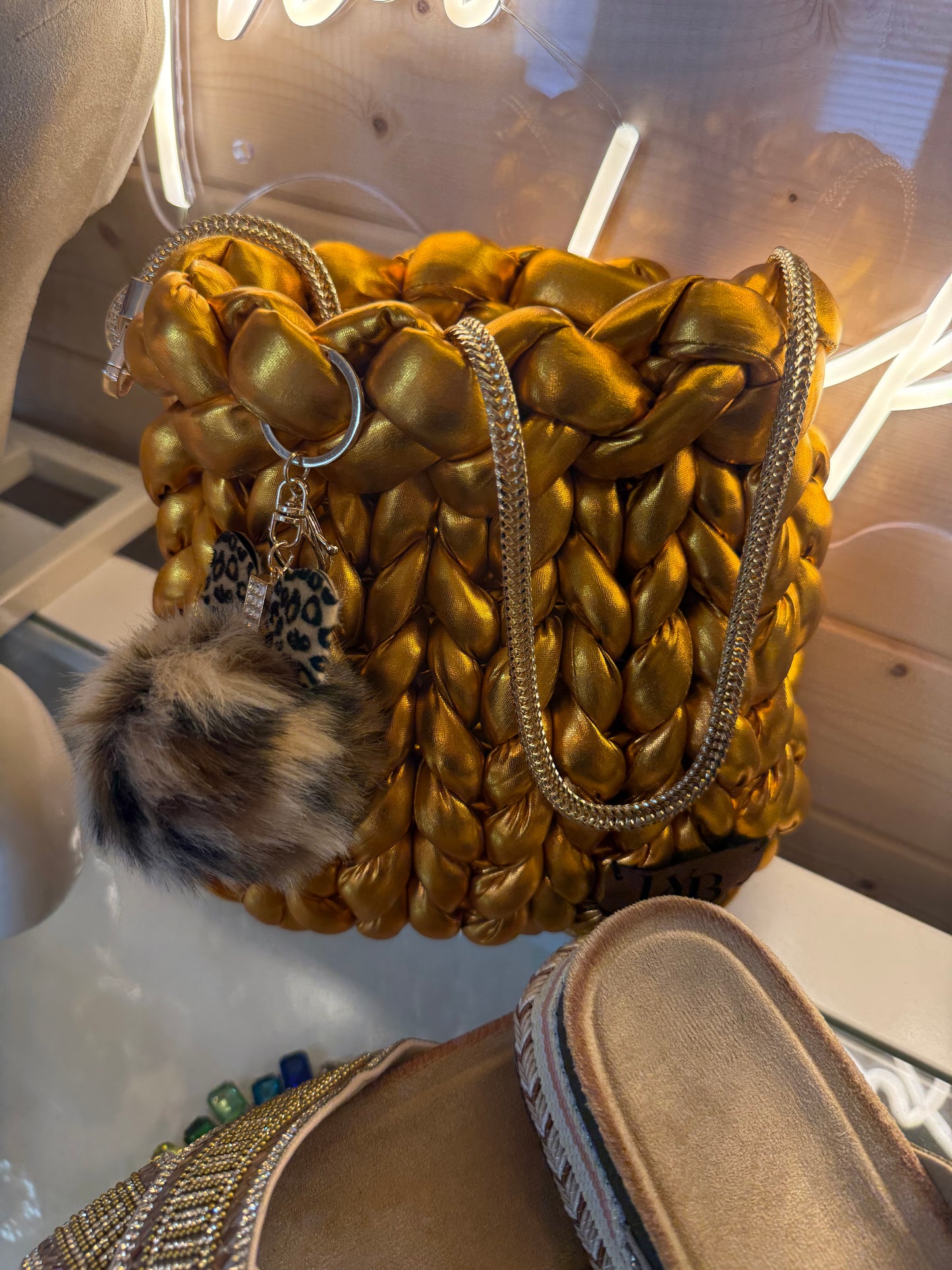 Gold rush metallic chunky braid bucket bag front view showing liquid gold braid texture and chain strap