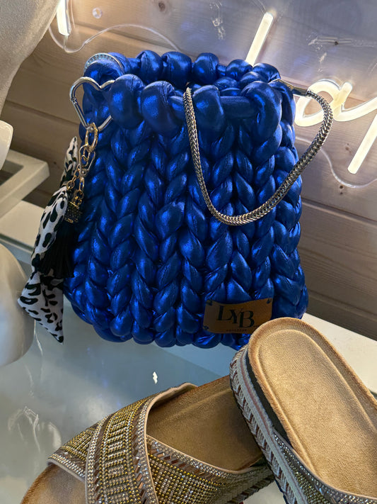 Cobalt blue metallic chunky braid bucket bag front view showing vivid blue braid texture and silver chain strap