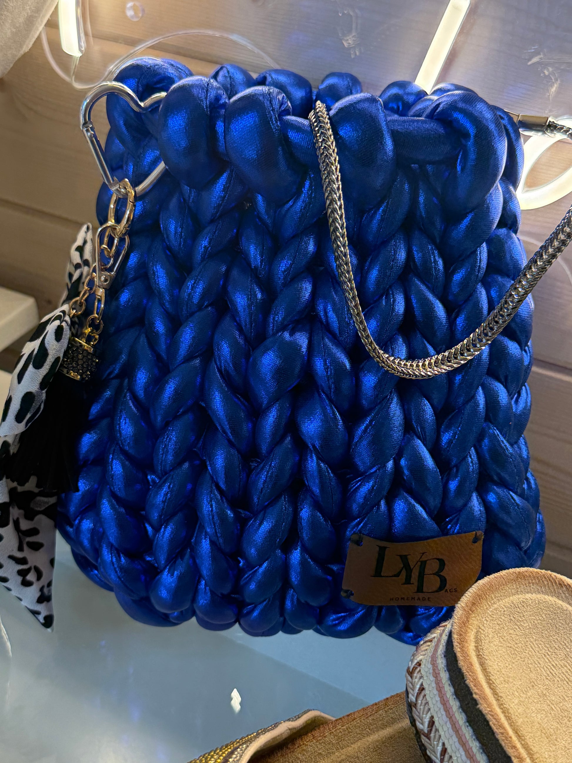 Cobalt blue metallic chunky braid bucket bag back view showing ULB branded label and heart carabiner clip