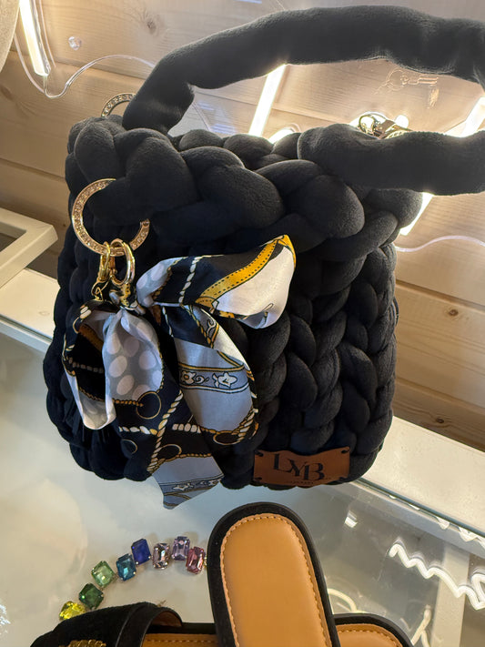 Midnight noir velvet chunky braid bucket bag front view showing black velvet braid texture and silk scarf charm