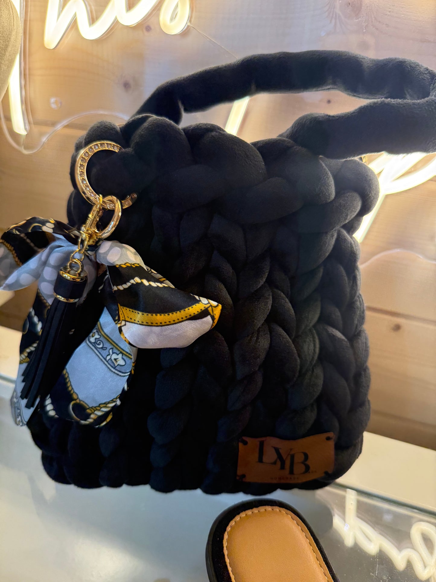 Midnight noir velvet chunky braid bucket bag side view showing chunky braided top handle and gold chain strap