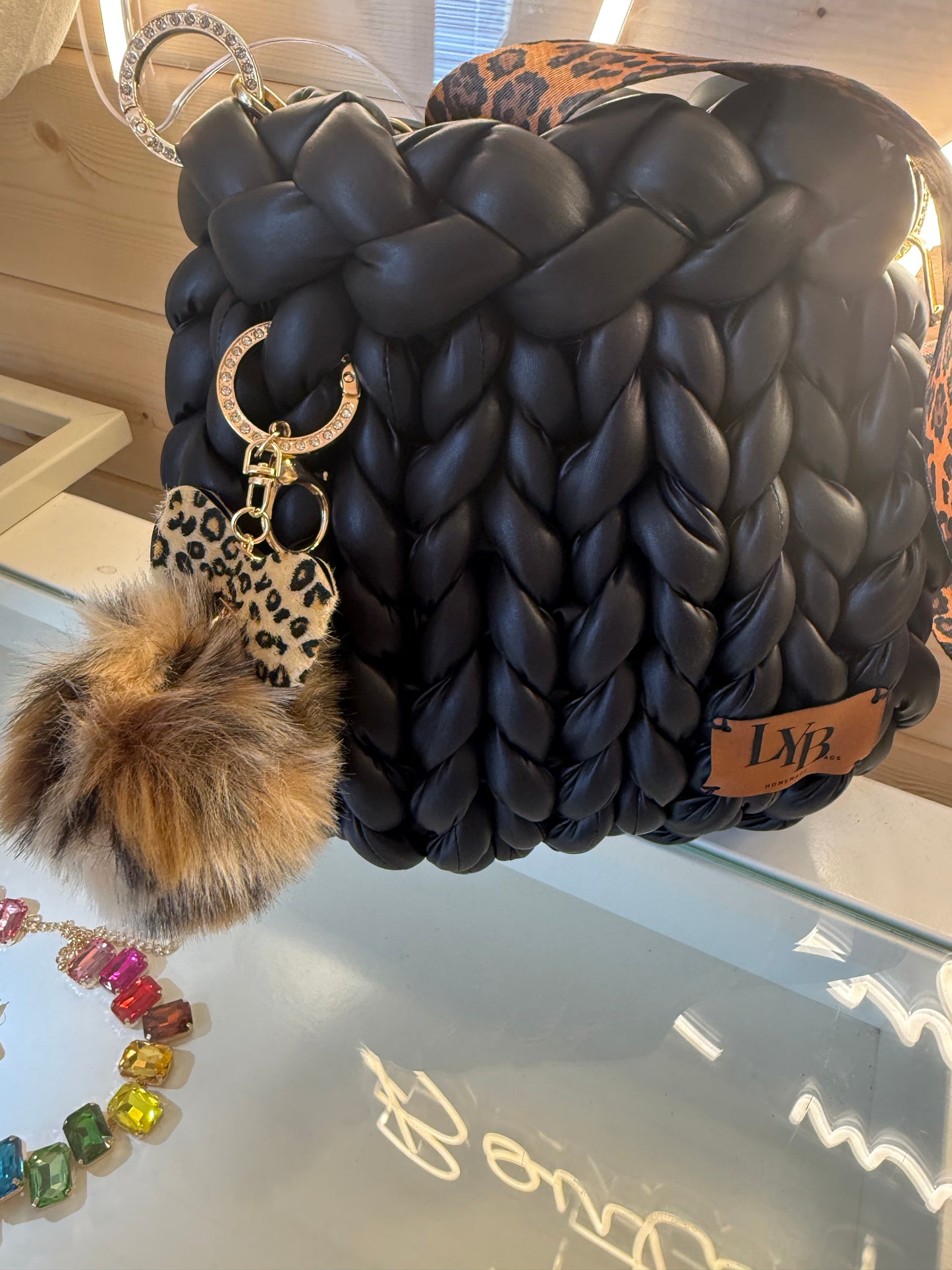 Wild at heart chunky braid faux leather bucket bag back view showing ULB branded label and diamanté crescent moon ring
