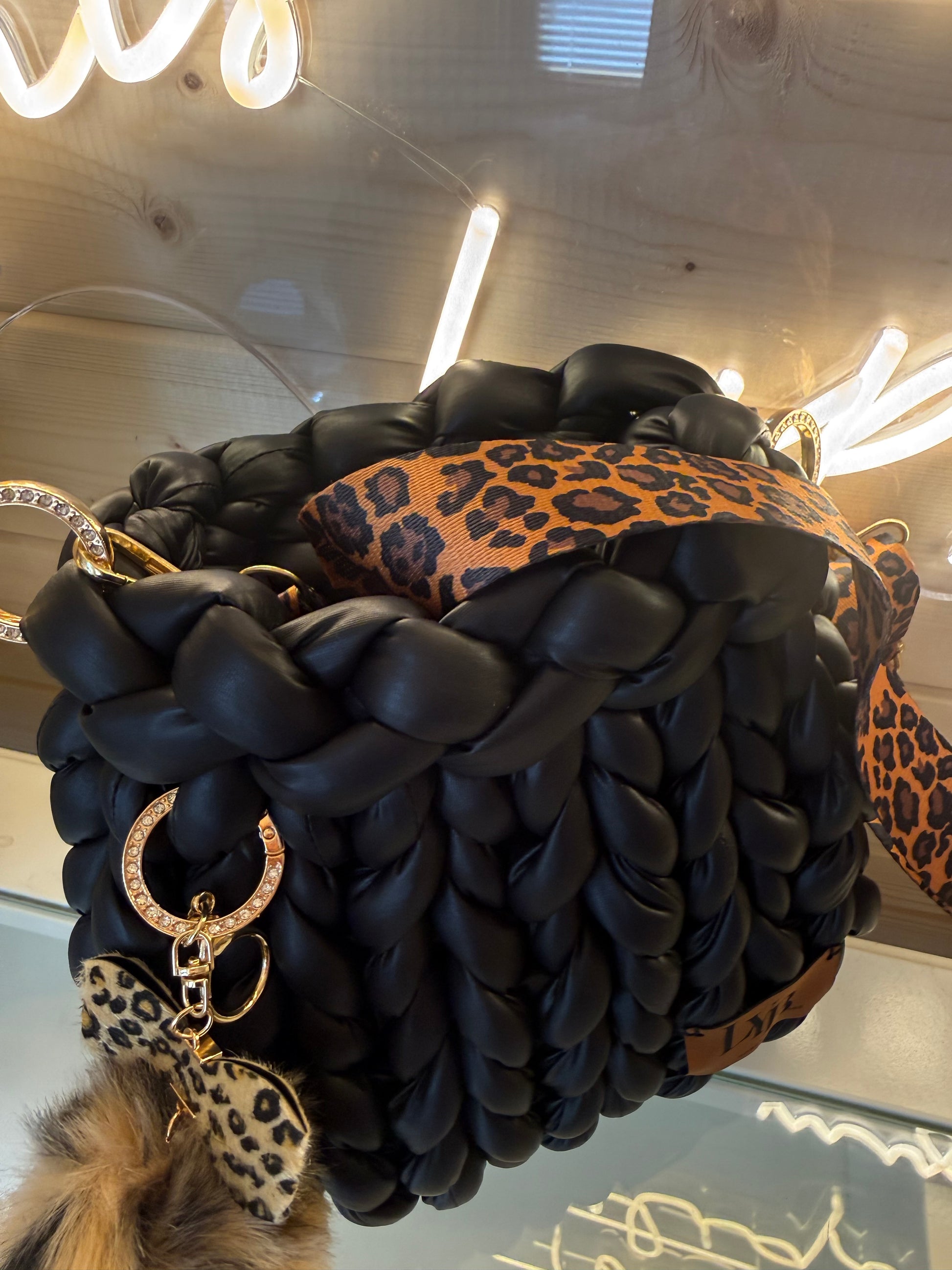 Wild at heart chunky braid faux leather bucket bag top view showing wide leopard print strap detail