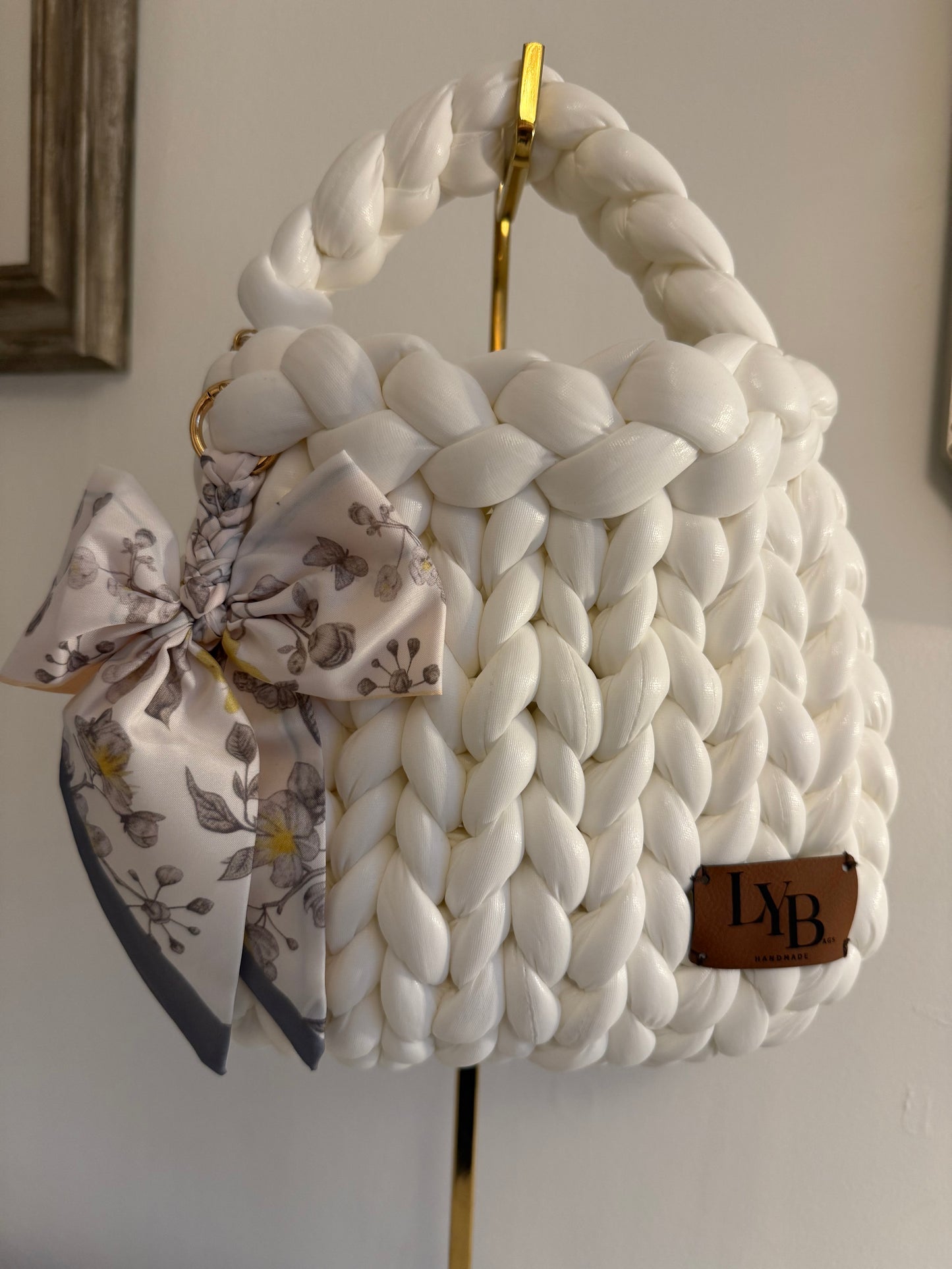 Arctic white braided bag showing open top interior with gold chain lining