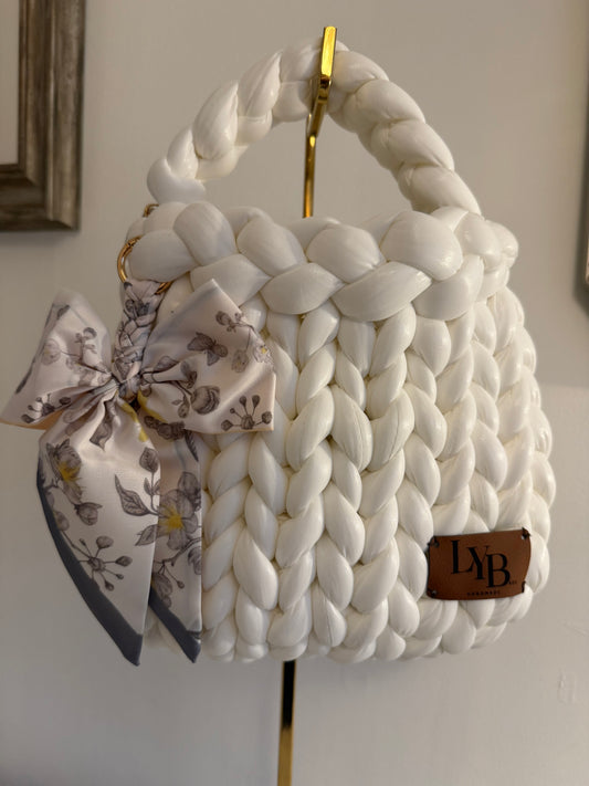 Arctic white braided bag showing open top interior with gold chain lining