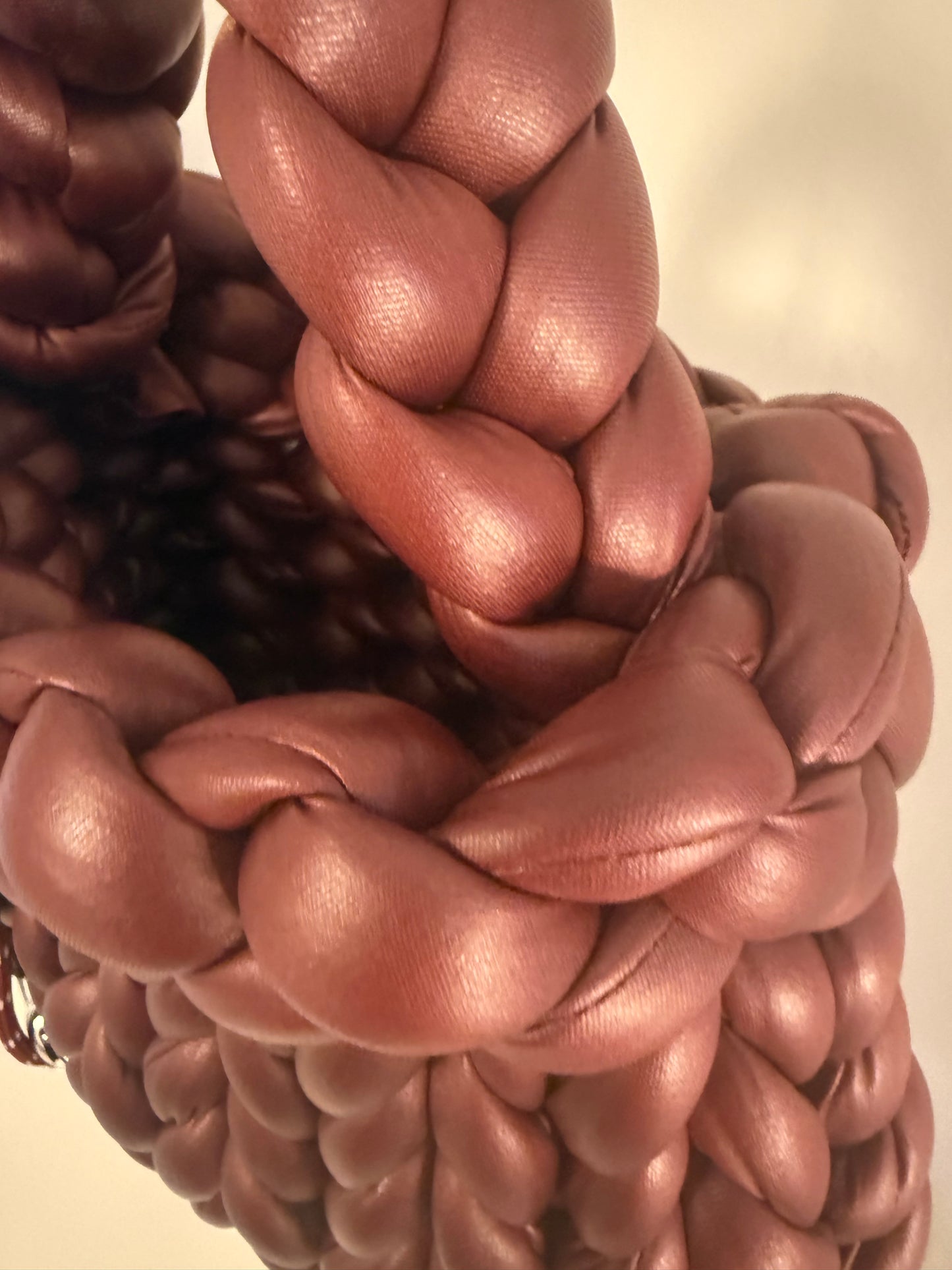 Close-up of chunky braided handle texture on Bordeaux burgundy luxury handbag