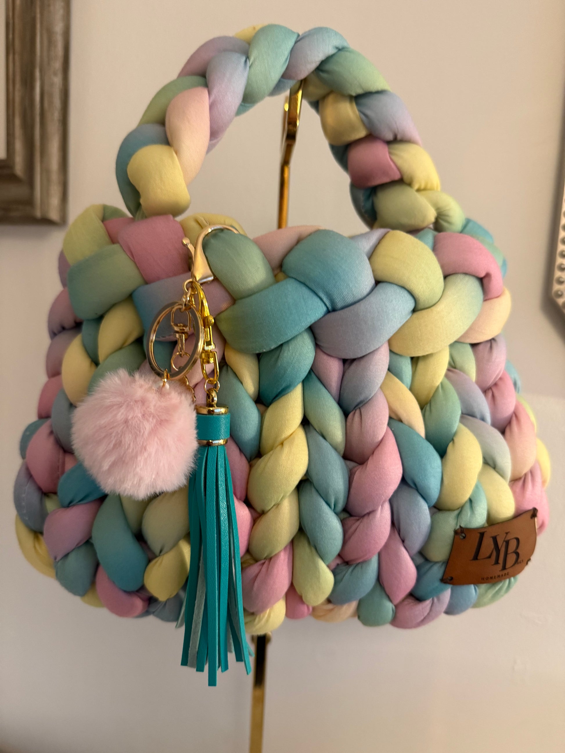 Candy pastel rainbow chunky braided bag with pom pom and teal tassel charm - front view