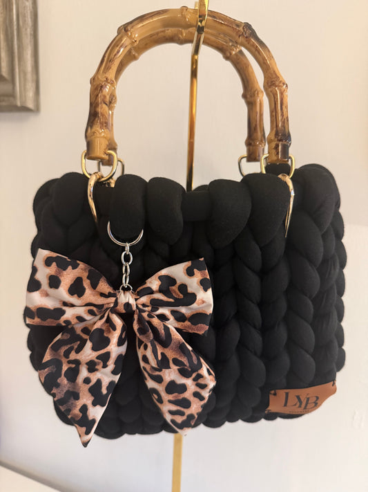 Chloe black chunky braid bag with lacquered bamboo handle and oversized leopard print bow charm - front view