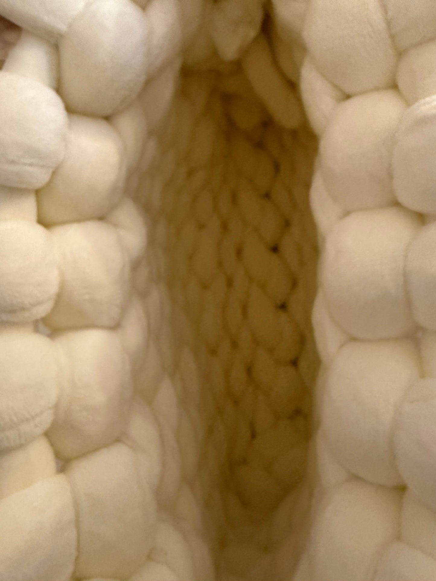Interior view of Pola chunky knit bag showing cream knitted base and open top design