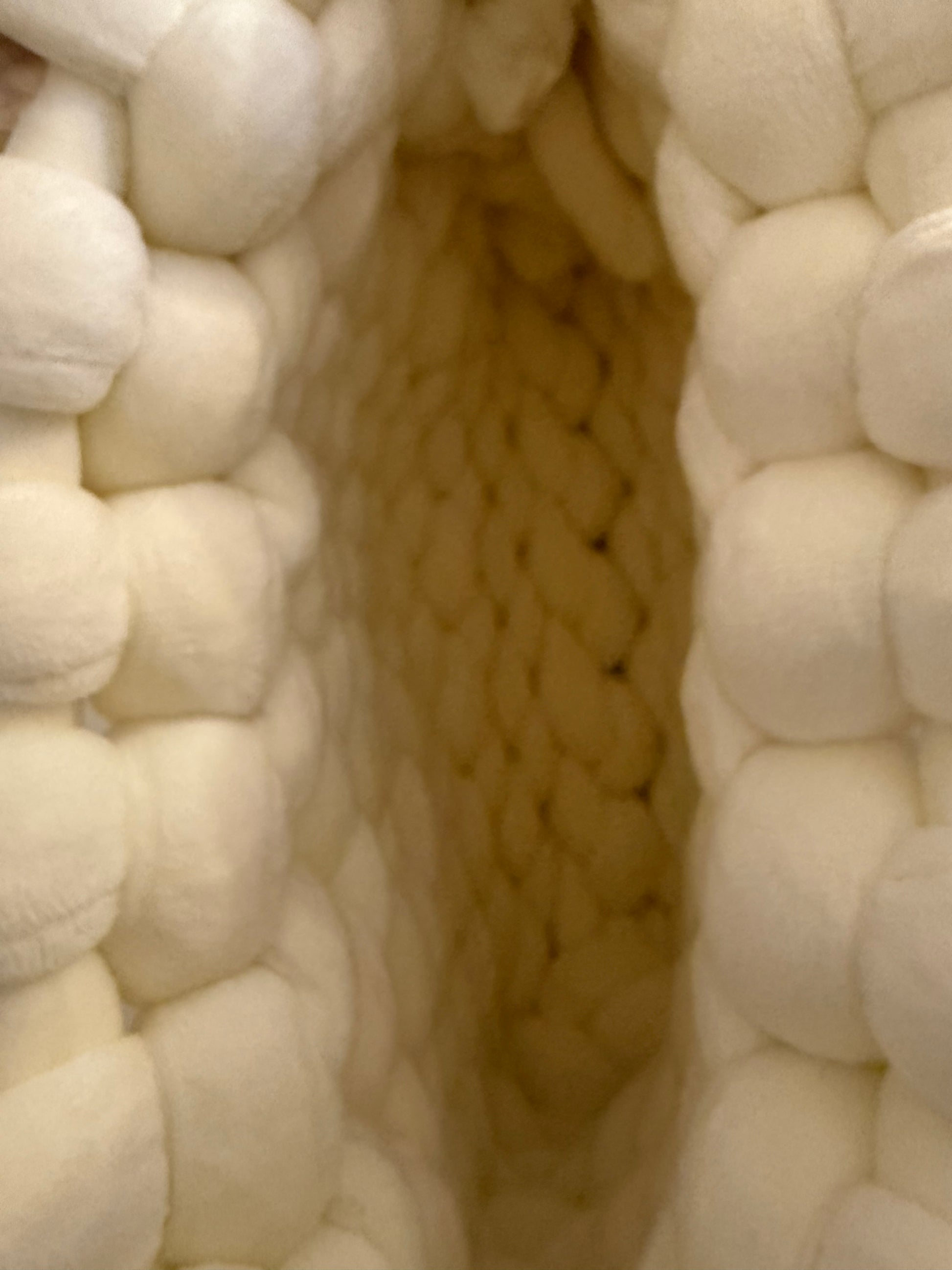 Interior view of Pola chunky knit bag showing cream knitted base and open top design