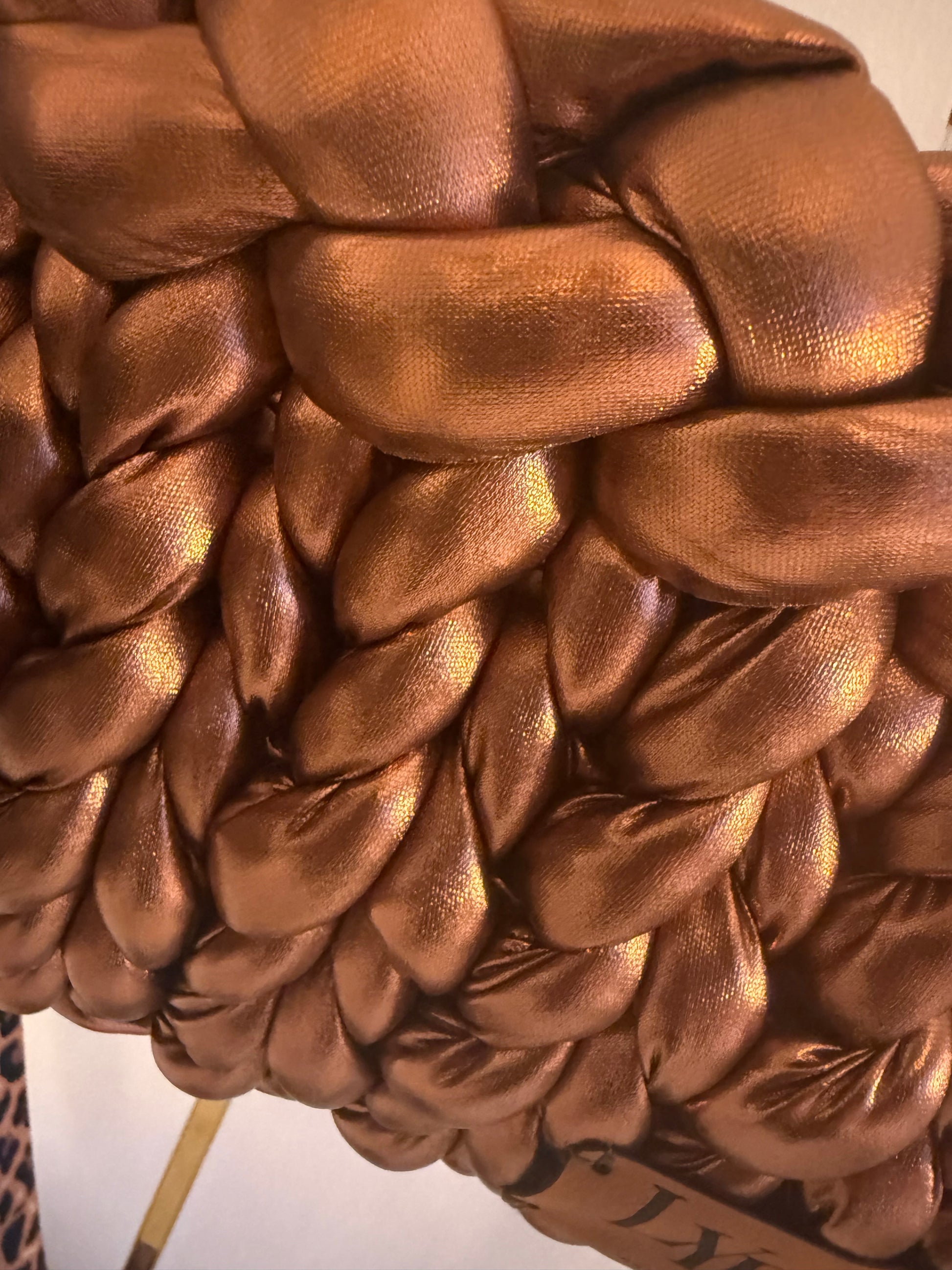 Close-up of metallic bronze chunky braid texture on Rustica luxury handbag