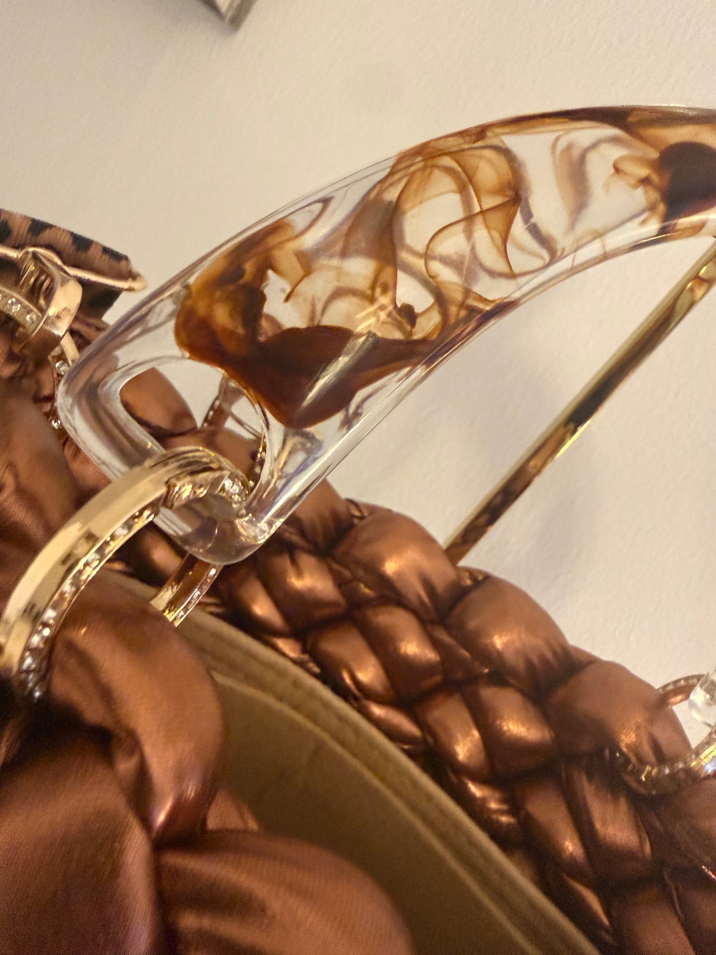 Close-up of marbled amber acrylic top handle with diamanté ring connectors on Rustica bag