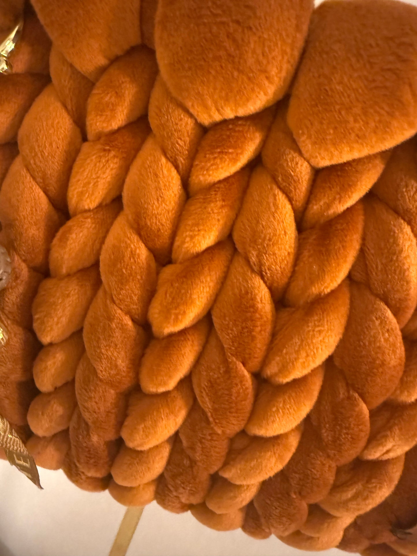 Close-up of burnt orange velvet chunky braid texture on Autumn Lust luxury handbag