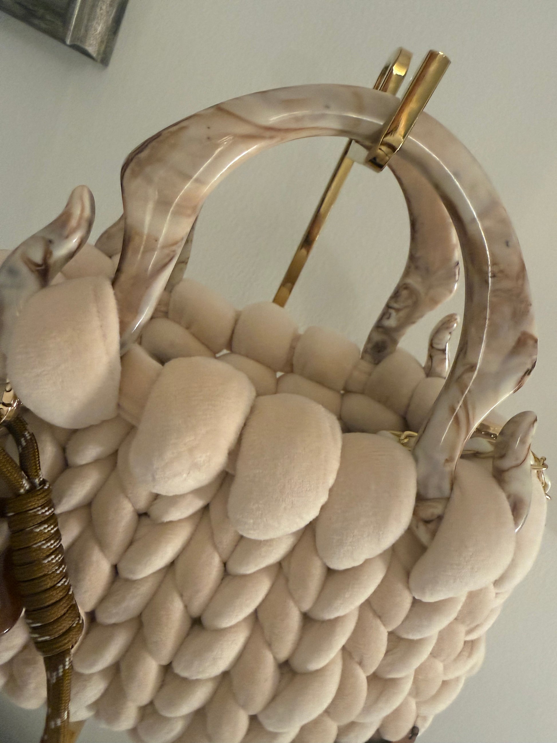 Close-up of marbled acrylic top handle on Mocha cream velvet chunky braid luxury handbag