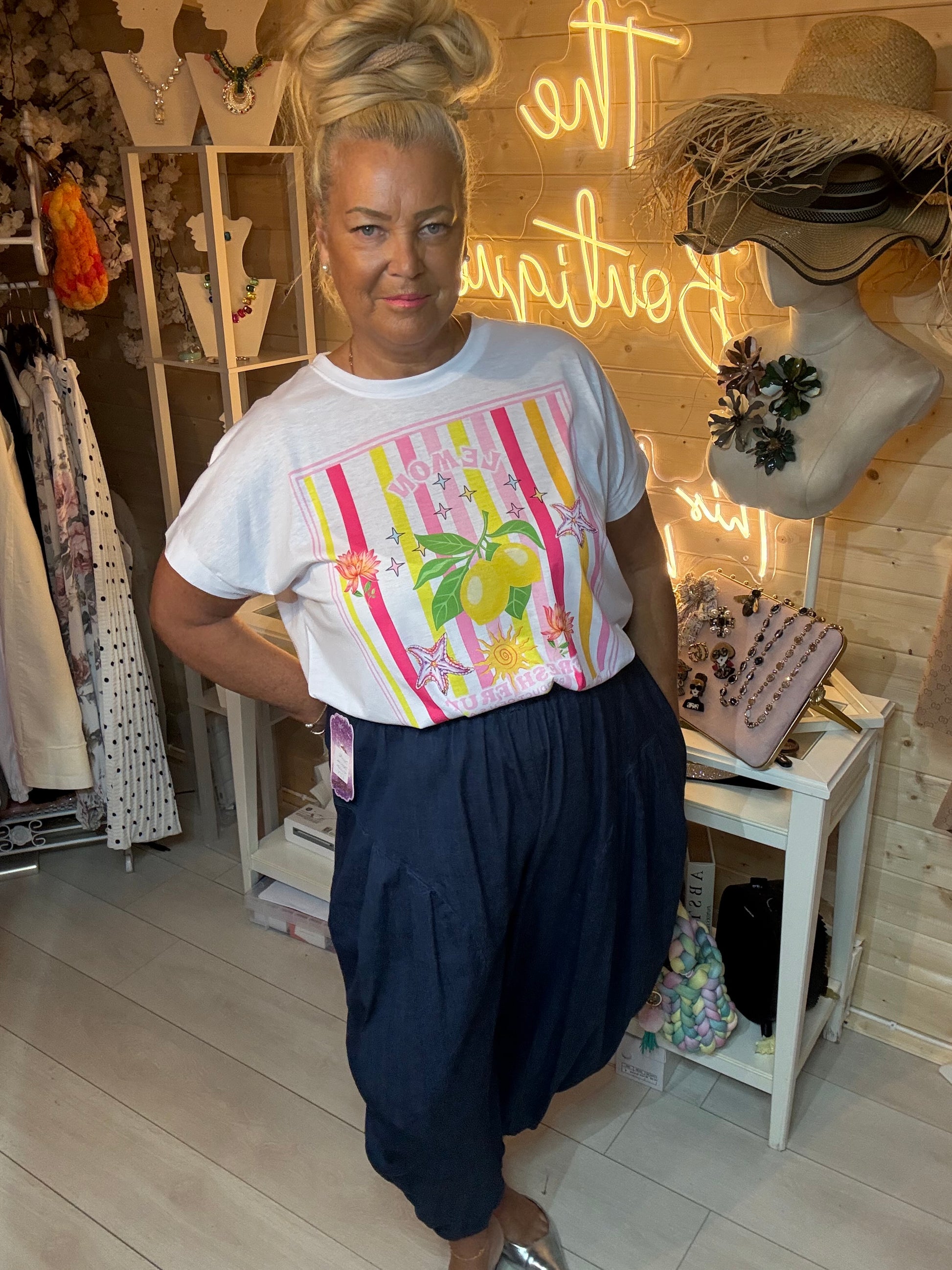 Front view of Limone lemon stripe graphic tee one size 8-18 styled with navy slouch trousers
