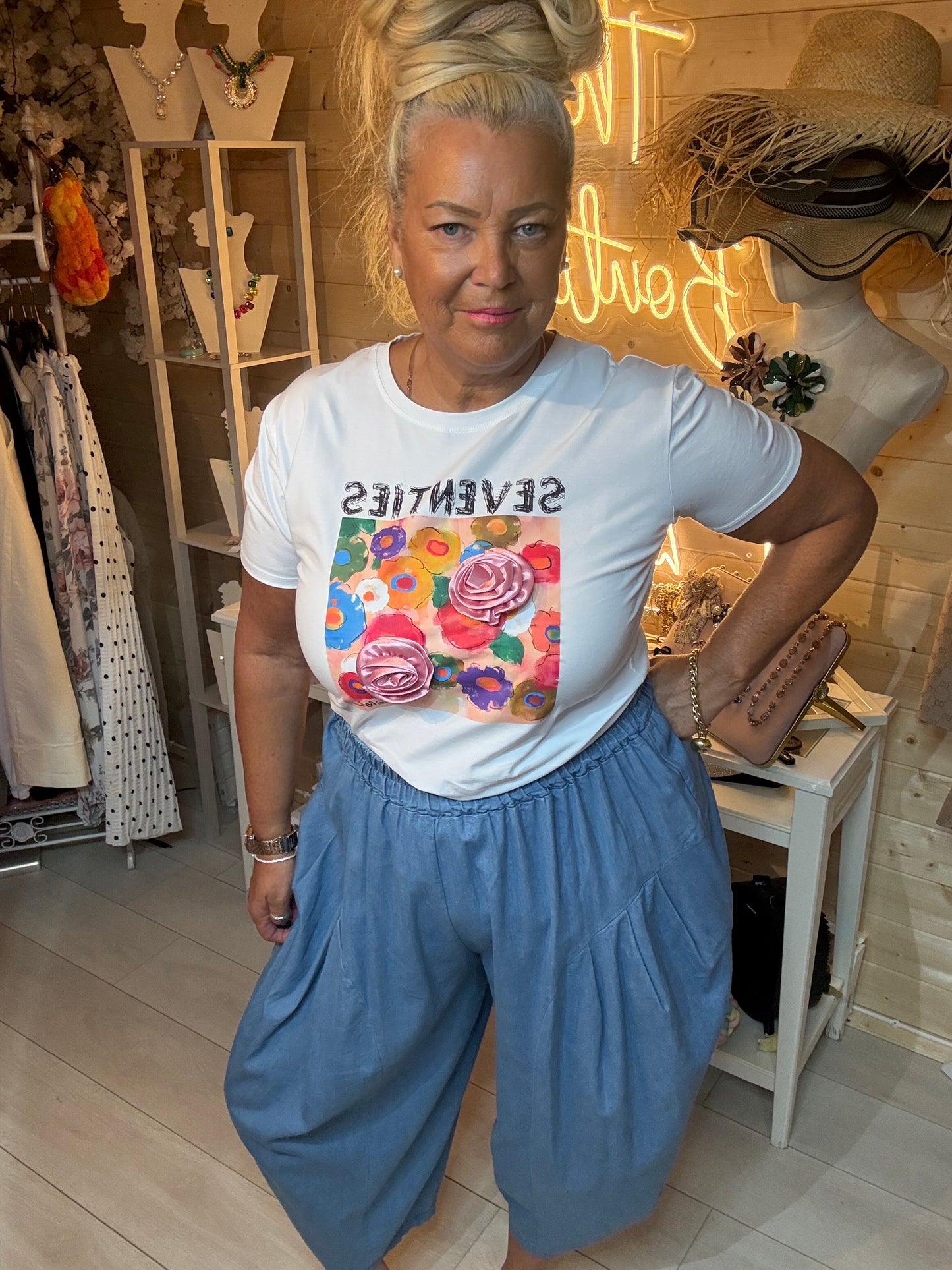 Seventies graphic t-shirt 3D rose appliqué – boutique styling with denim harem trousers full length view