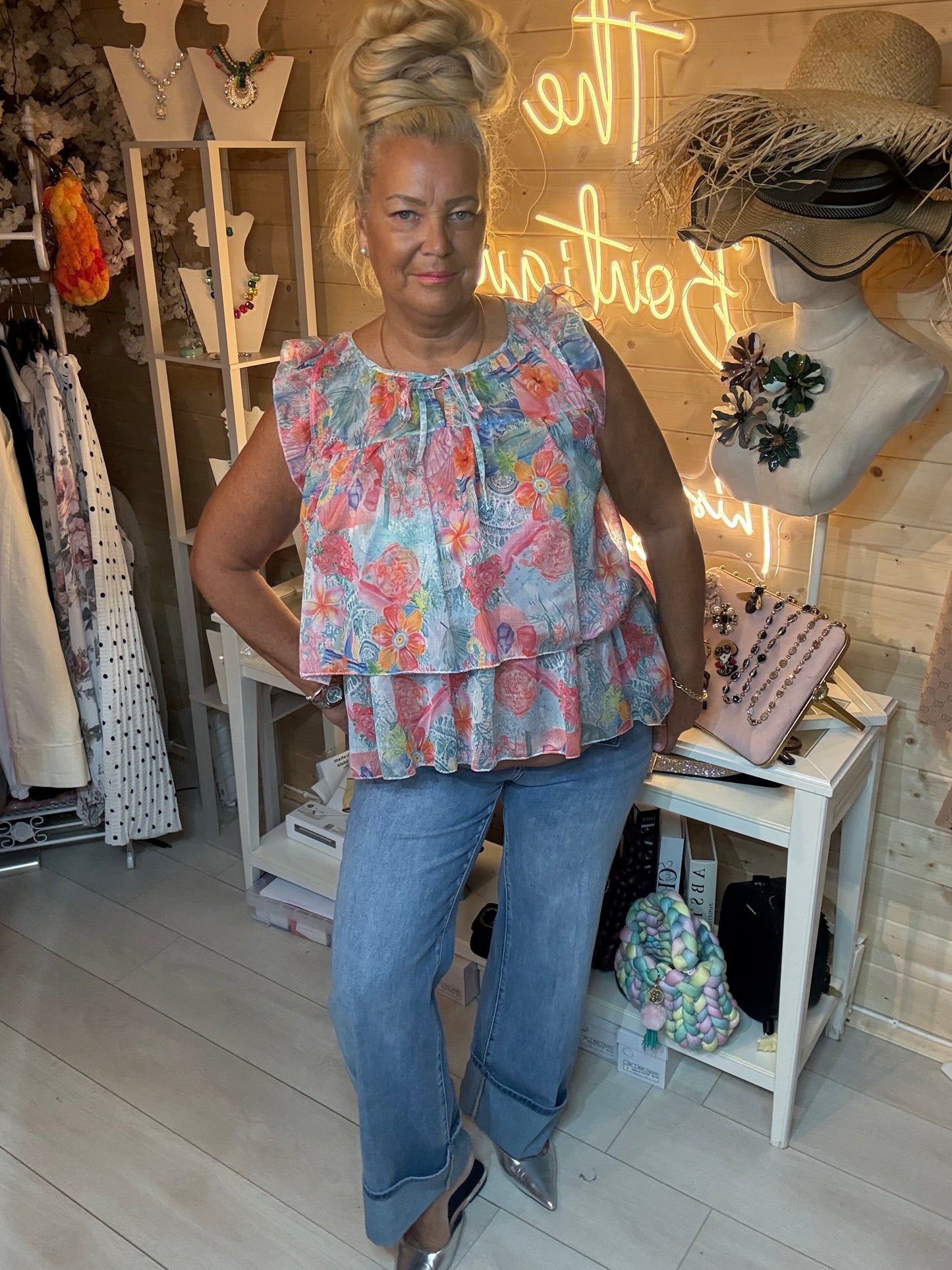 Flora tiered peplum floral blouse with coral pink and blue tropical print – side angle