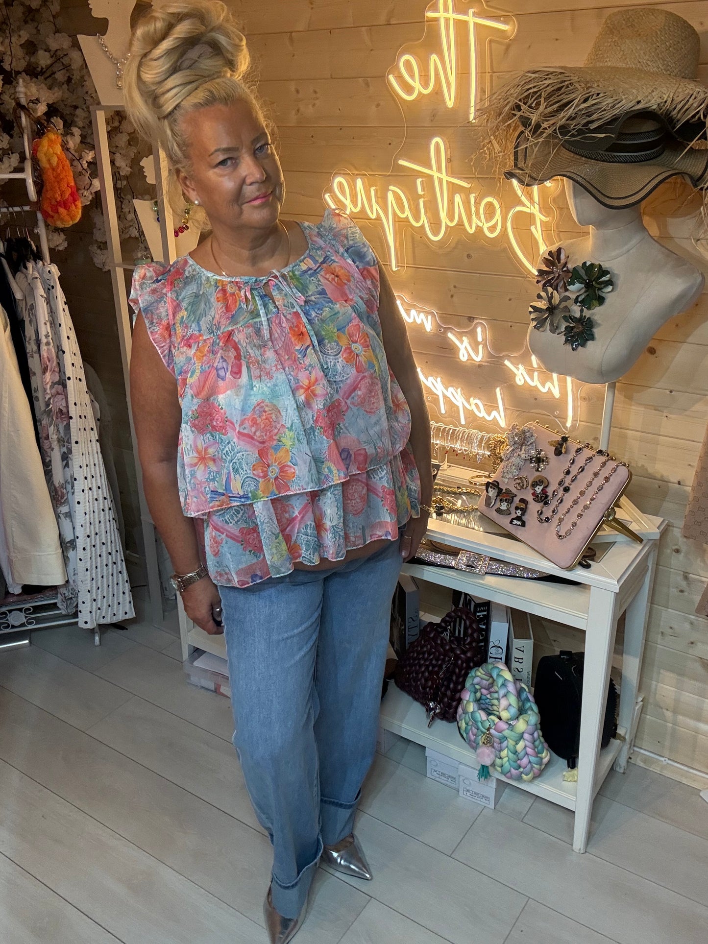 Close up of Flora floral chiffon top showing frill shoulder and gathered tie neckline detail