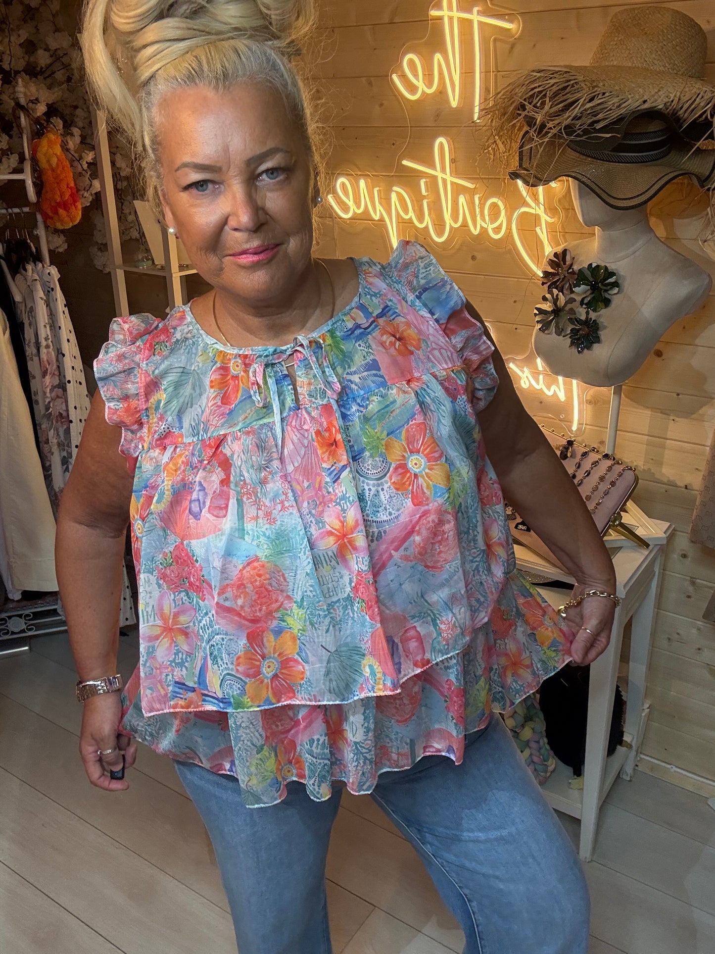 Flora boutique floral ruffle top full length view with denim jeans
