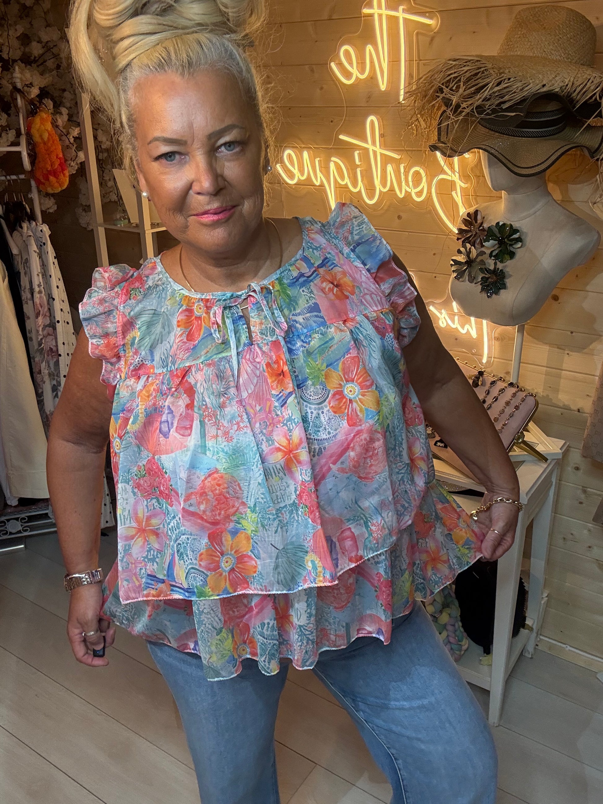 Flora boutique floral ruffle top full length view with denim jeans