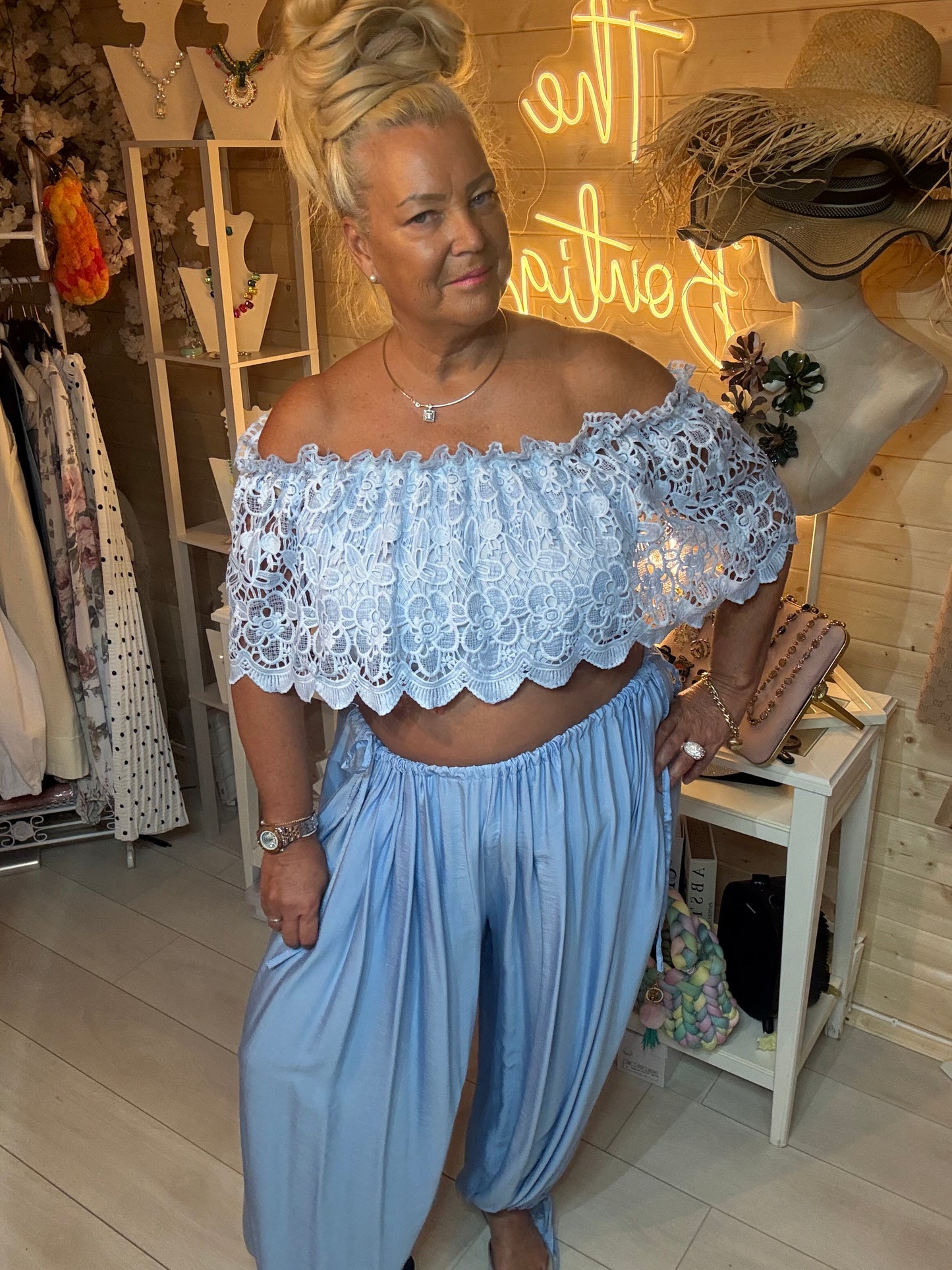 Close up of Azure floral crochet lace overlay and scalloped hem detail – off shoulder bardot top