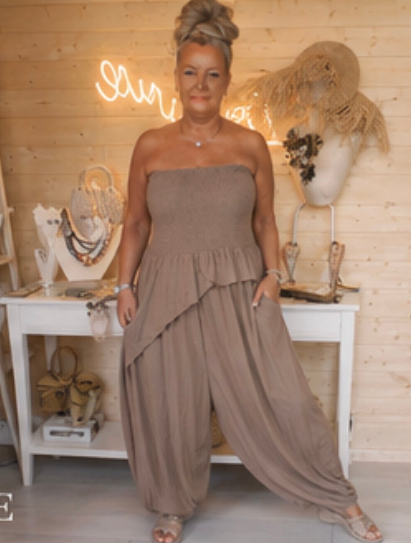 Riviera mocha strapless peplum jumpsuit – boutique front view showing wide-leg harem trousers and layered frill detail