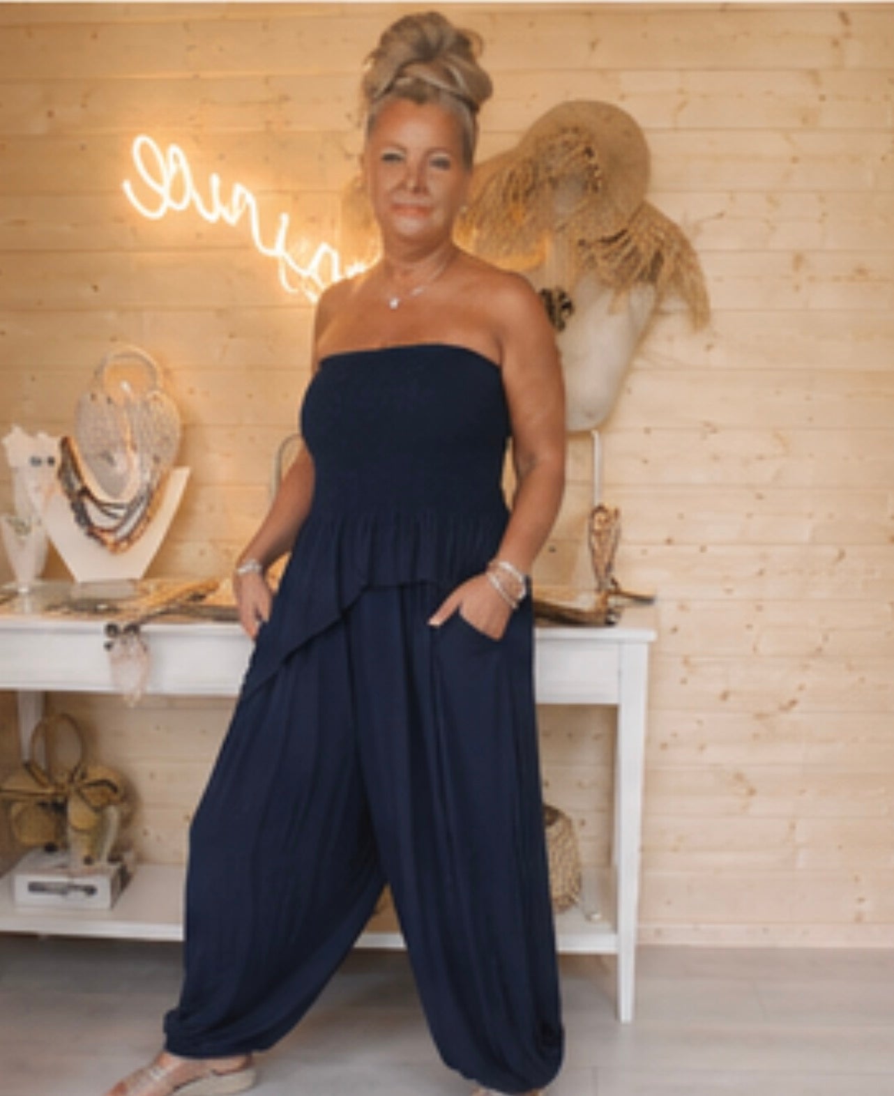 Riviera navy strapless peplum jumpsuit one size 8-18 – boutique front view showing smocked bandeau and frill peplum hem