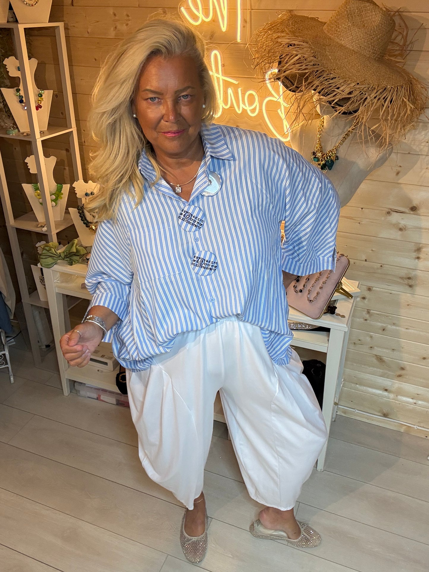 Breton Stripe Oversized Batwing Shirt - seated front view showing badge detail and batwing sleeve - One Size 12-20 - The Ultimate Ladies Boutique