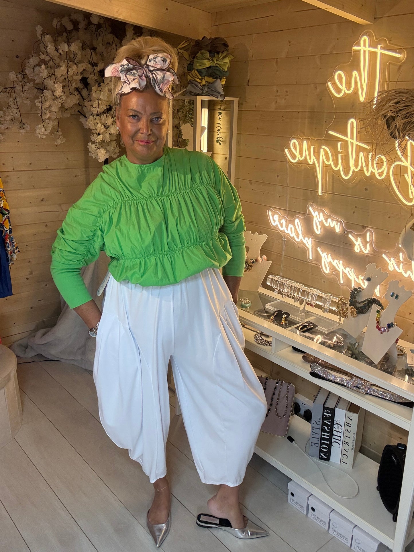 Lola lime green peplum top full length view styled with white trousers