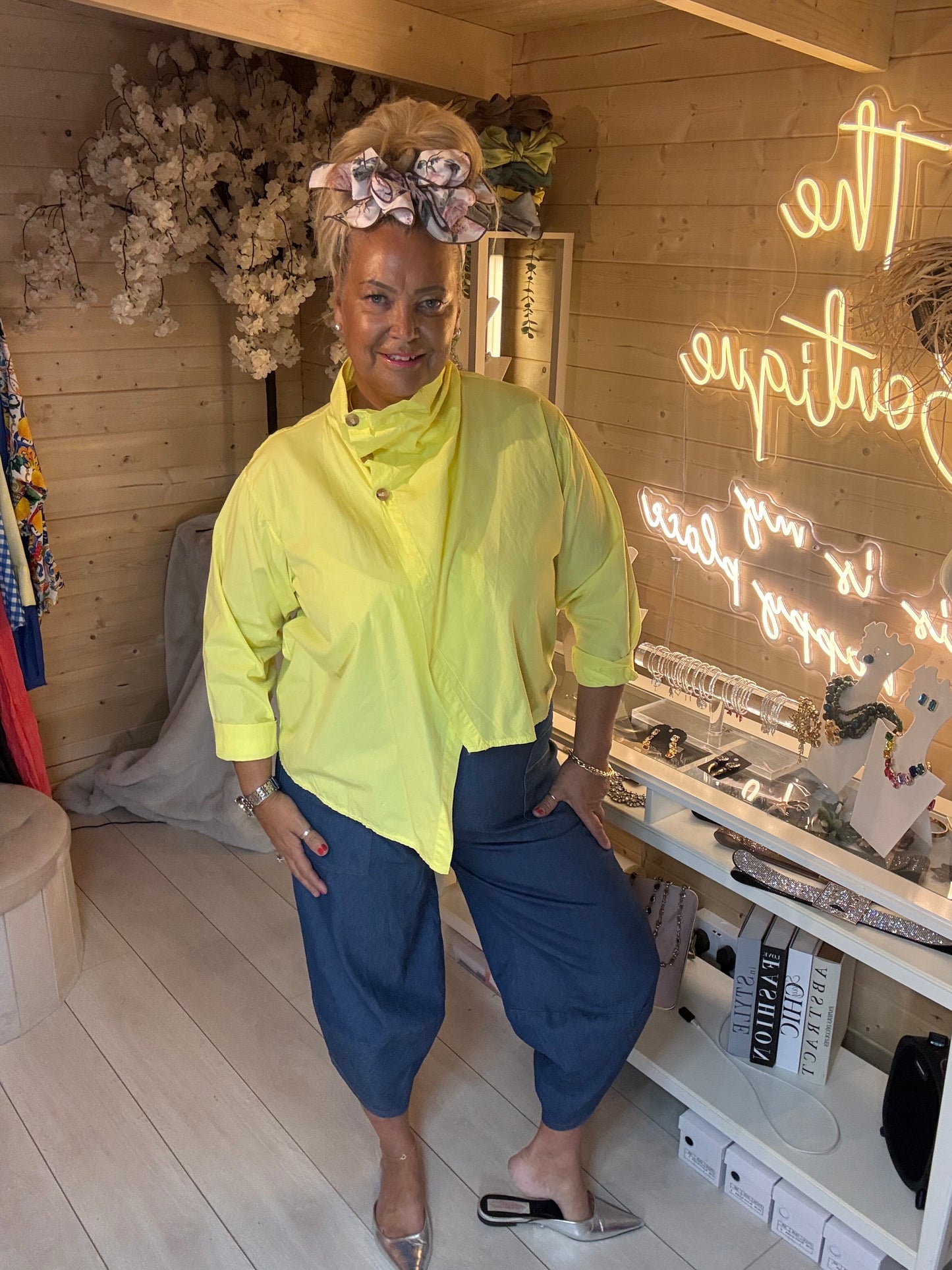 Cannes yellow wrap jacket top styled with blue trousers – full length view
