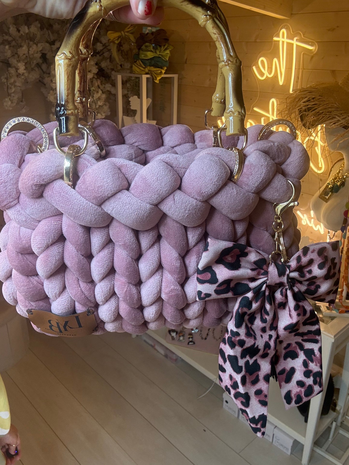 Lavinia lilac chunky woven tote bag with gold bamboo handle and leopard bow charm – front view
