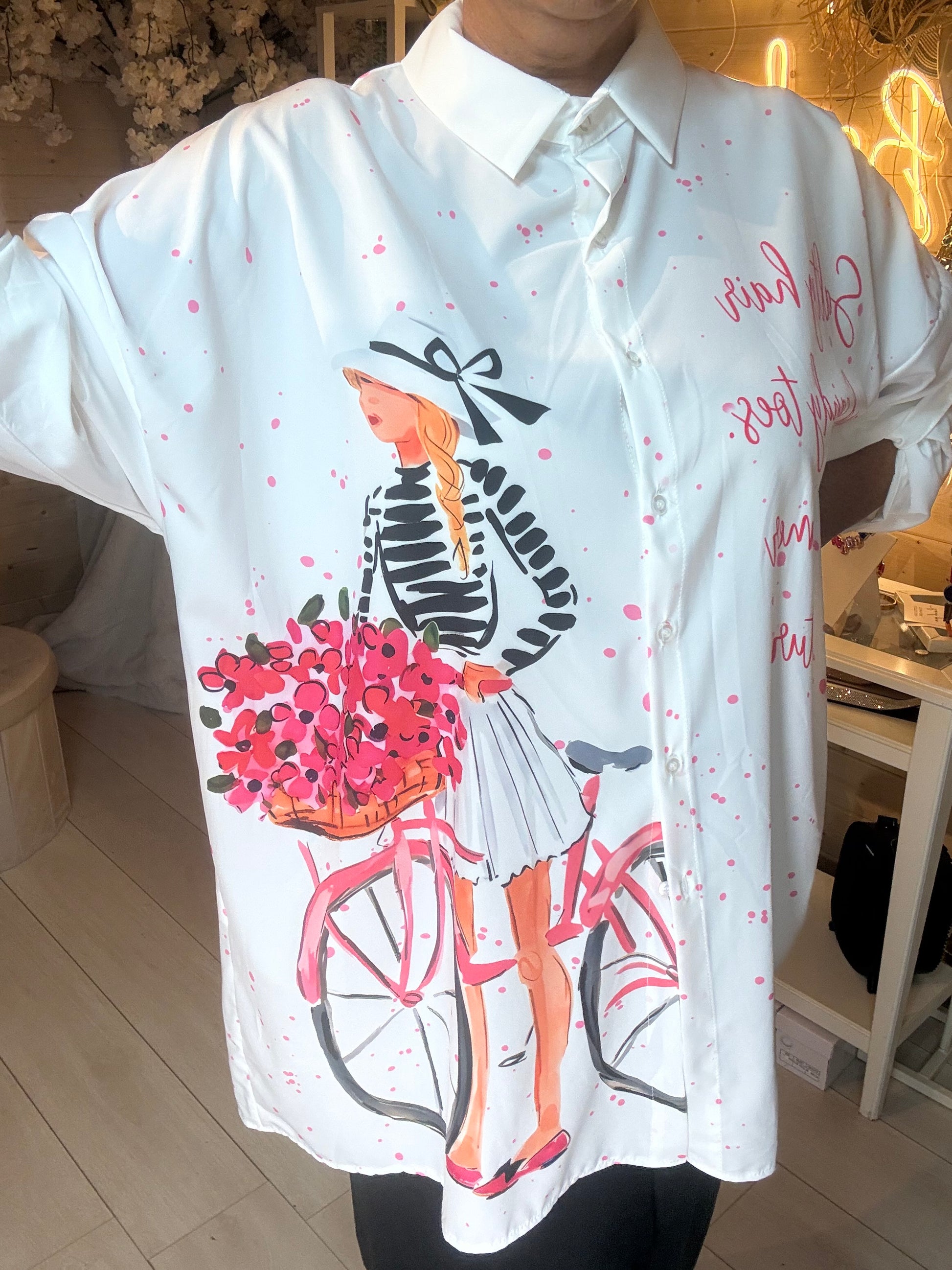 Colette oversized shirt close-up of Parisian girl bicycle print and pink splatter detail