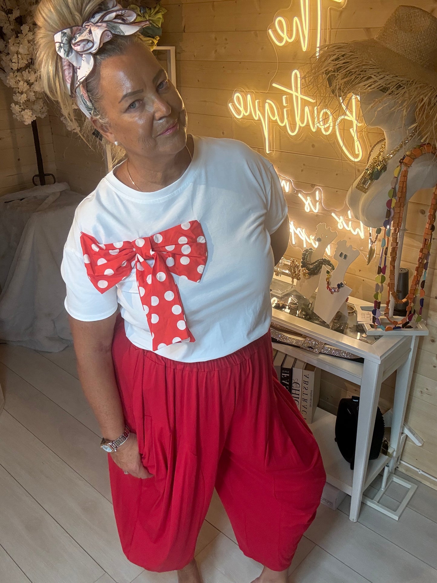 Minnie bow t-shirt three quarter view on model styled with red harem trousers – boutique outfit
