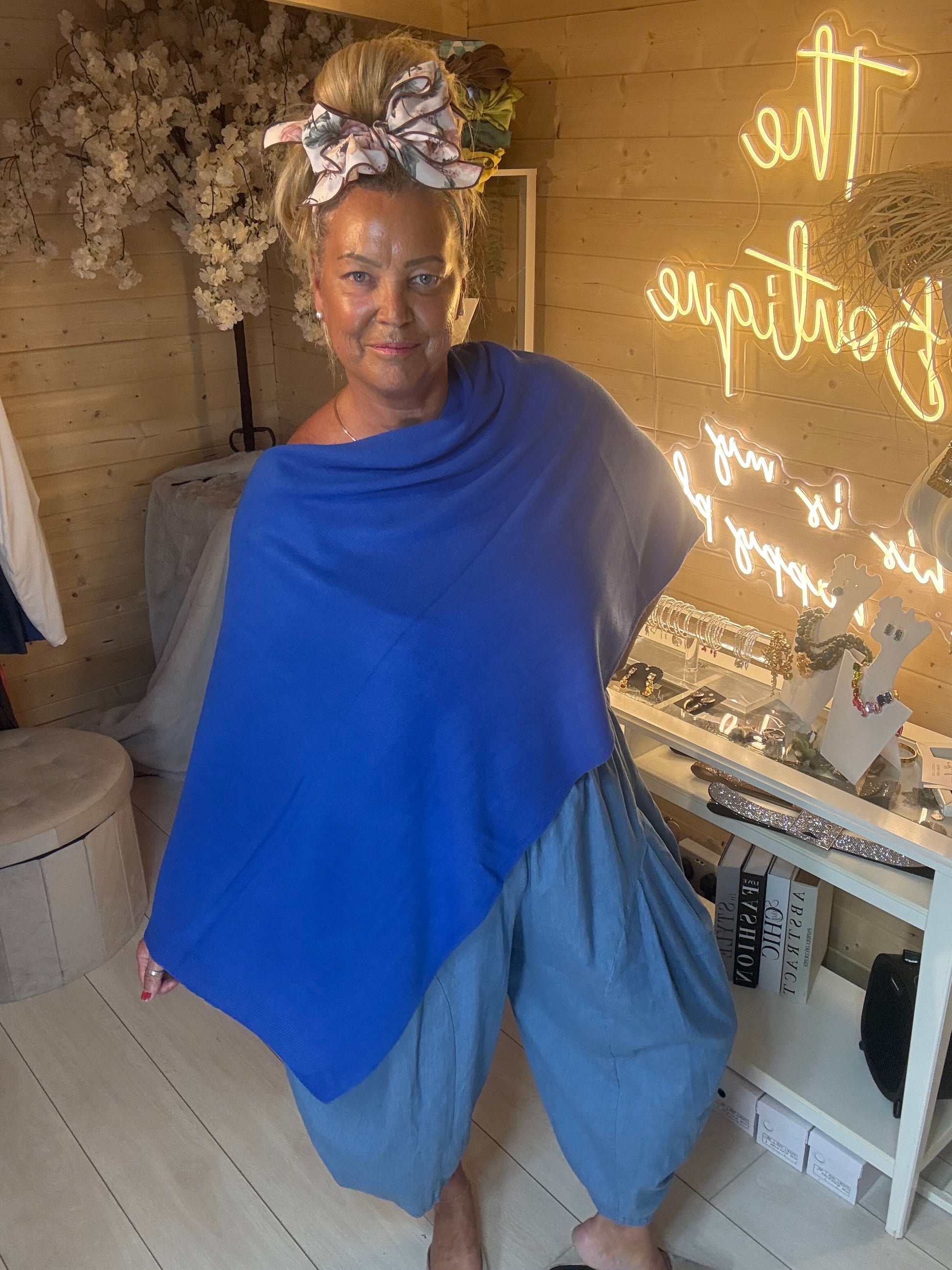 Brezza cobalt blue poncho cape close-up front view showing soft knit fabric and cowl neckline