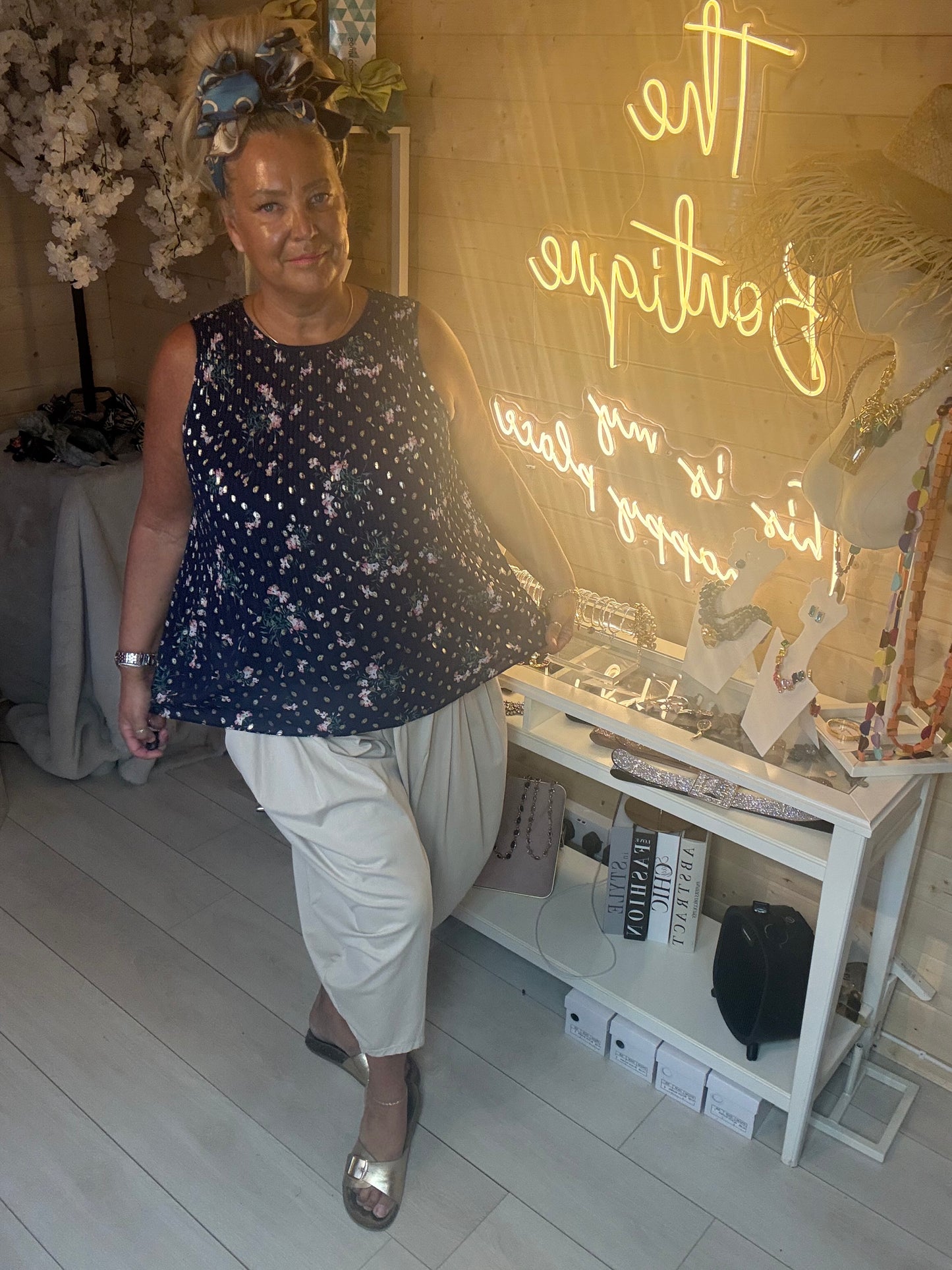 Capri Navy Floral Crinkle Sleeveless Top full length view styled with stone slouch trousers and silver sandals