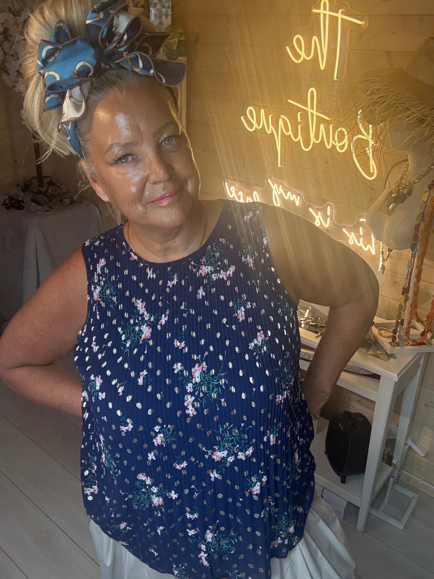 Close up of Capri Navy Floral Crinkle Sleeveless Top showing ditsy floral print and crinkle texture detail