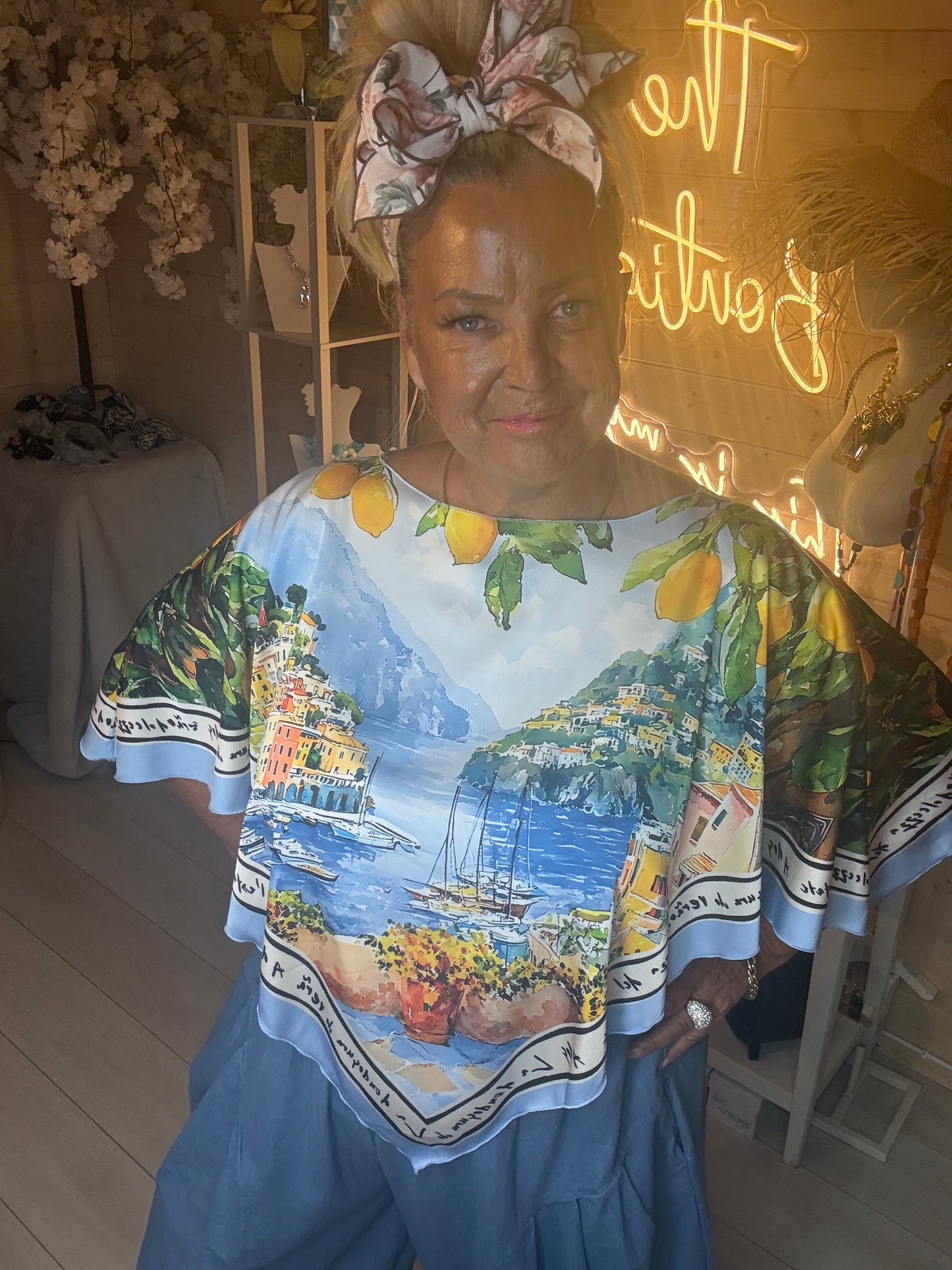 Close up of Amalfi Poncho Top showing detailed Italian coastline scenic print with lemon border