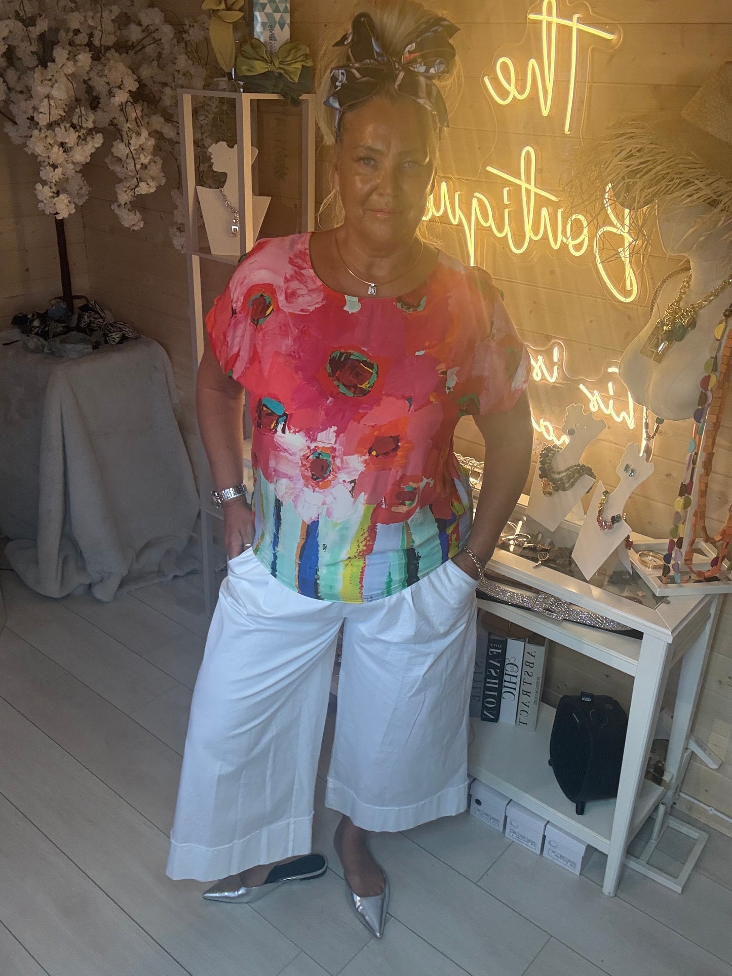 Sorento Coral Abstract Floral Poncho Top styled with coral harem trousers and silver heels full length view