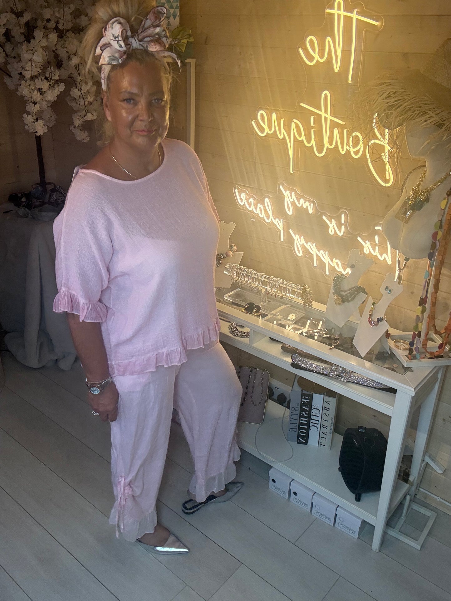 Close up of model wearing Rosa Blush Pink Ruffle Hem Crinkle Top showing ruffle hem detail and crinkle fabric texture