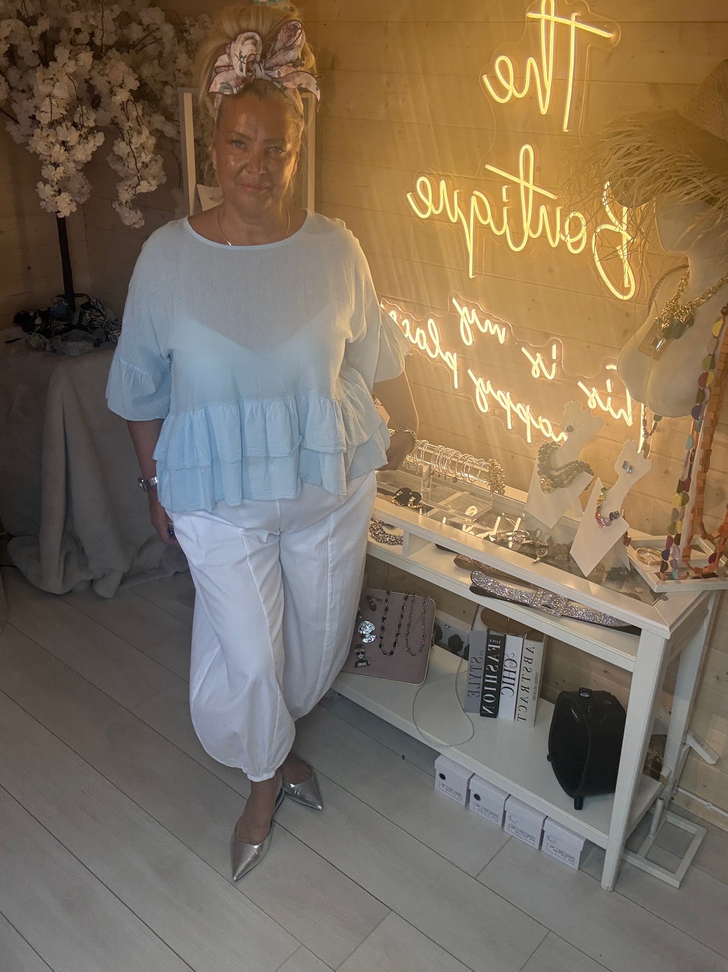 Sky Blue Tiered Ruffle Hem Top styled with white boom trousers full length outfit view with silver heels one size 8-18